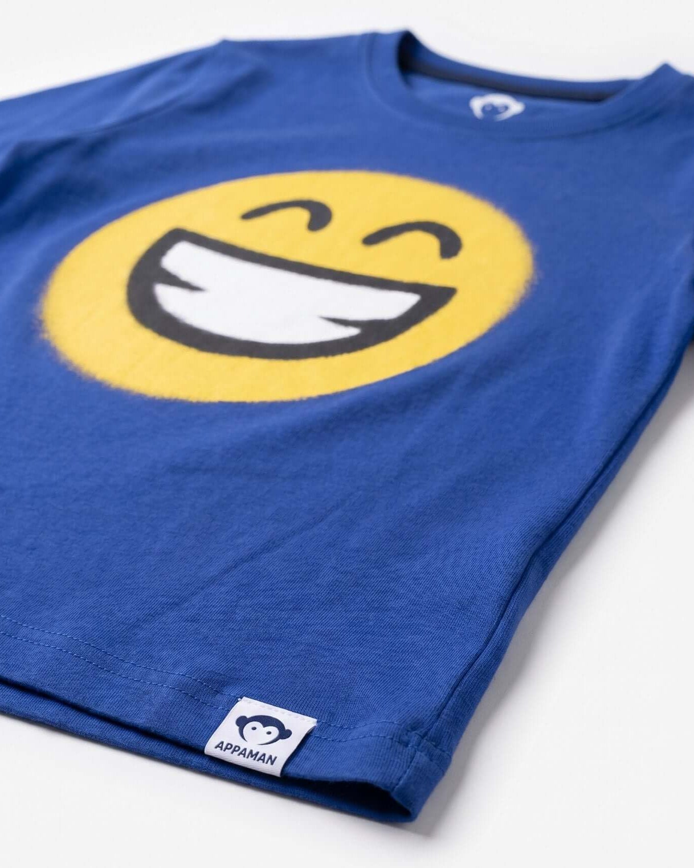 Blue t-shirt with a smiley face design on a white background
