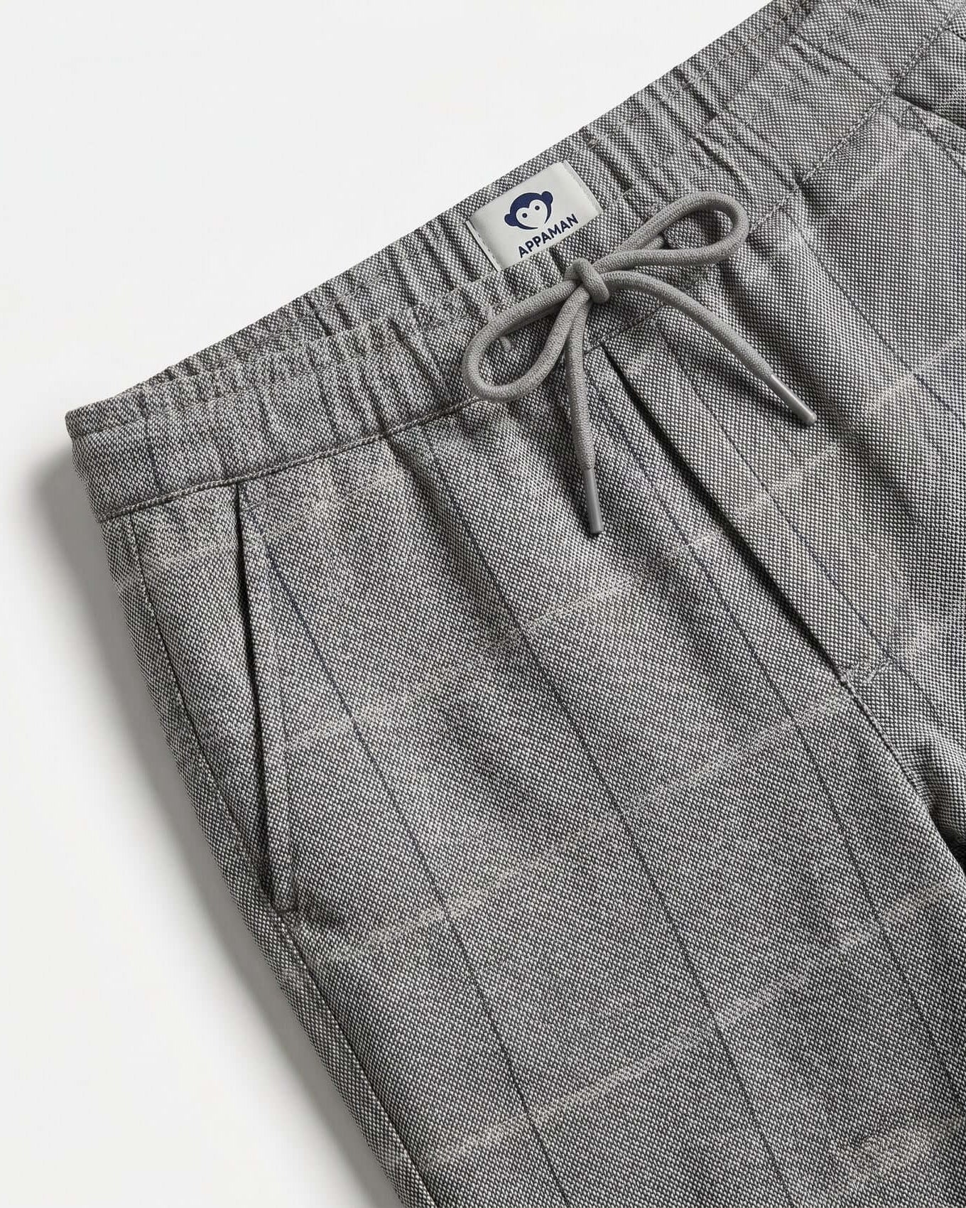 Gray checkered pants with drawstring on a white background