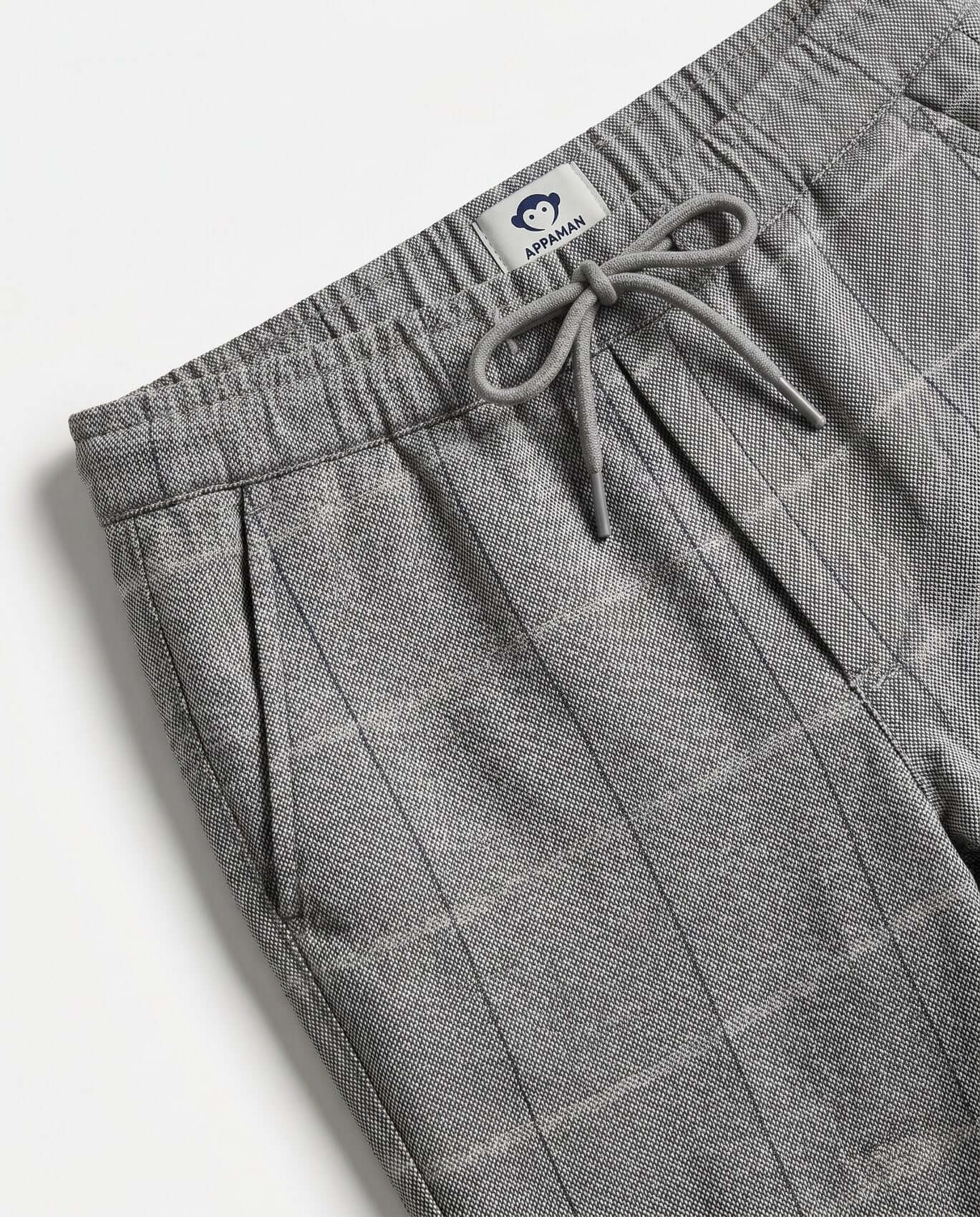 Gray checkered pants with drawstring on a white background