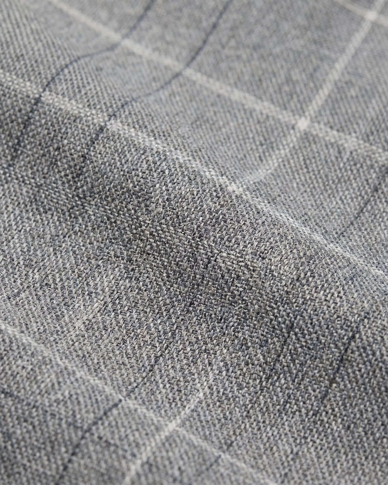 Close-up of gray fabric with a subtle check pattern