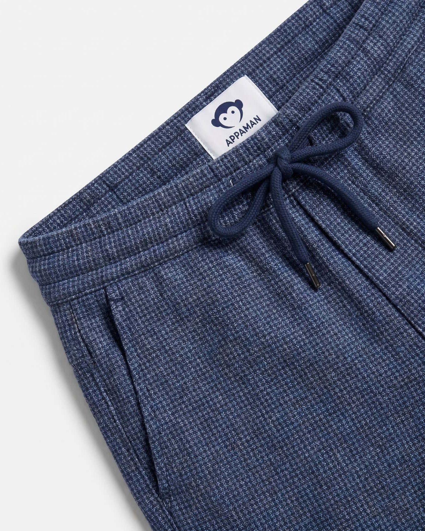 Blue pants with a drawstring and Appaman label on a light gray background