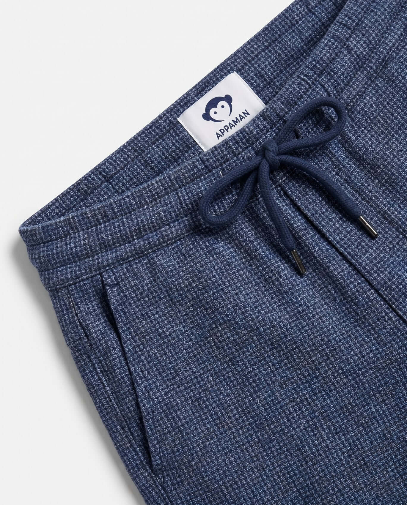 Blue pants with a drawstring and Appaman label on a light gray background