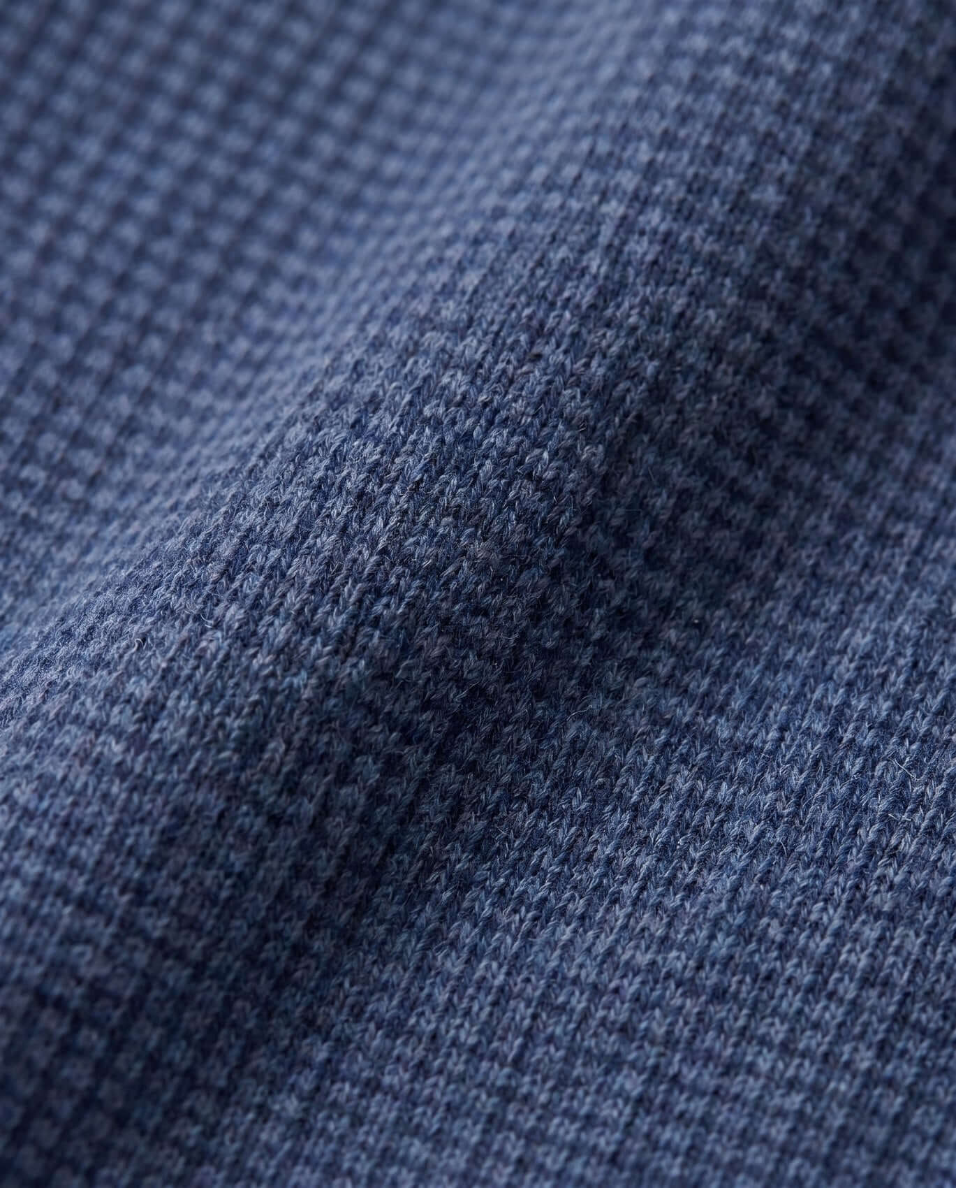 Close-up of blue denim fabric with a subtle pattern