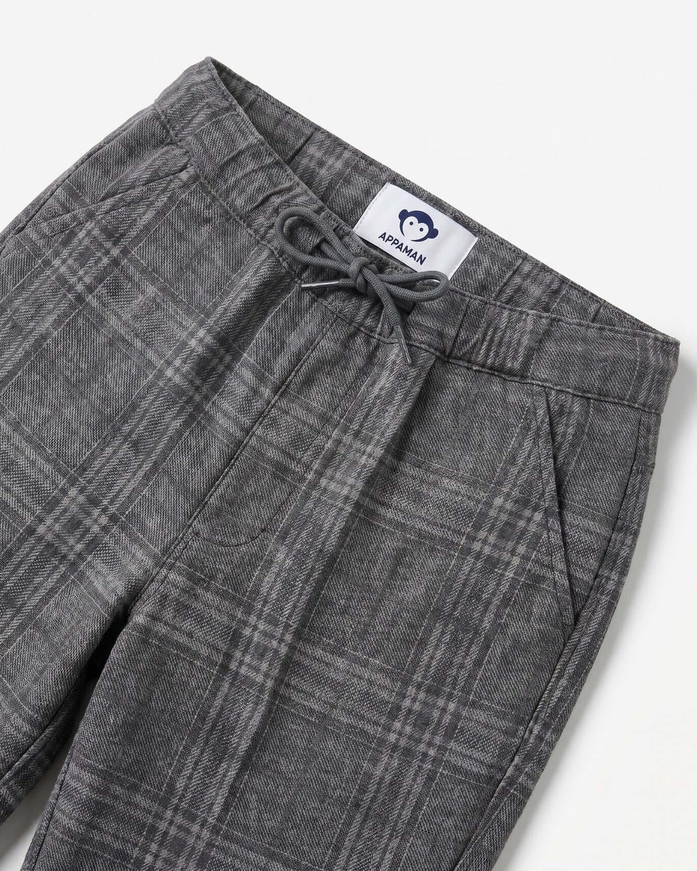 Gray plaid pants with a brand label on a white background