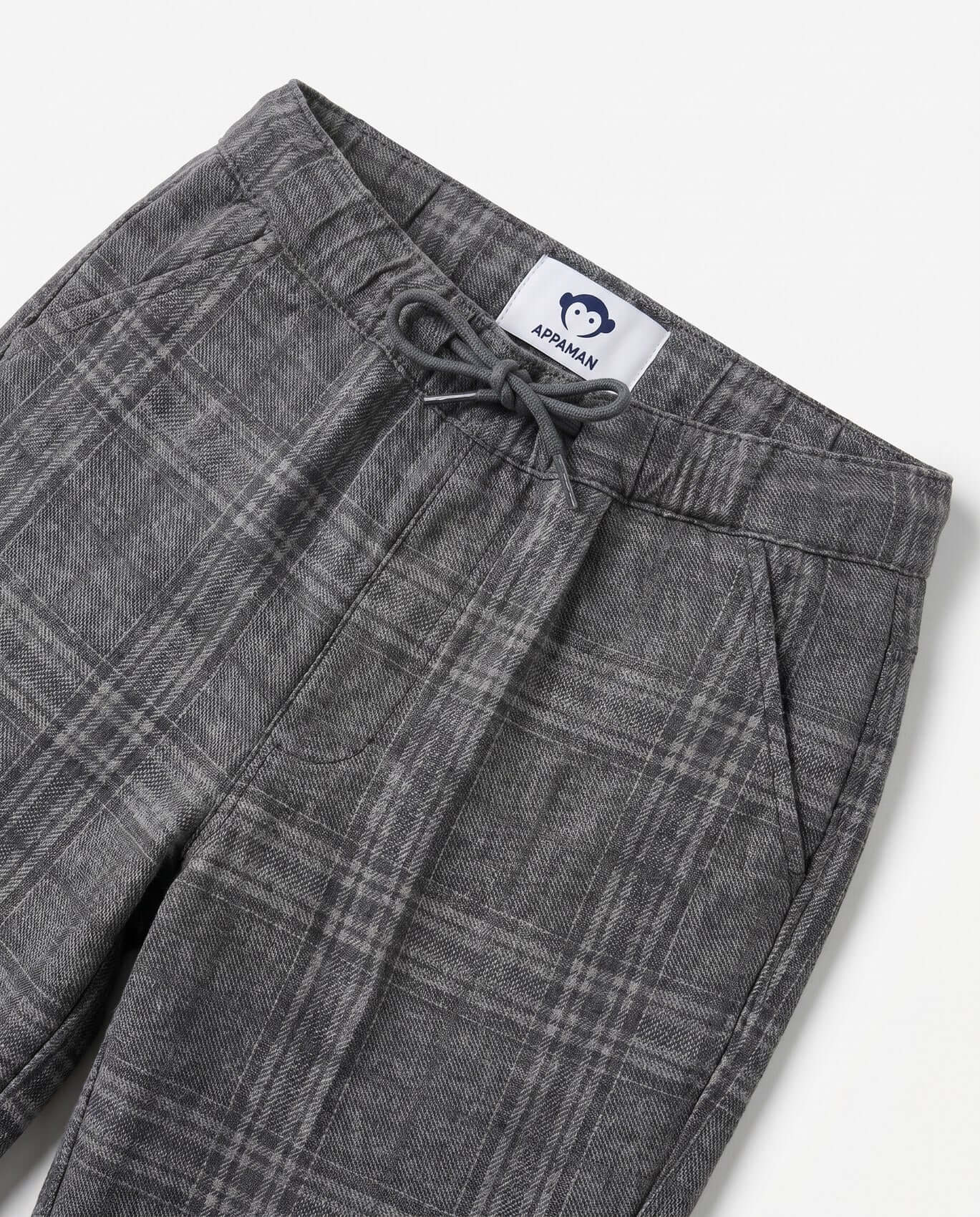 Gray plaid pants with a brand label on a white background