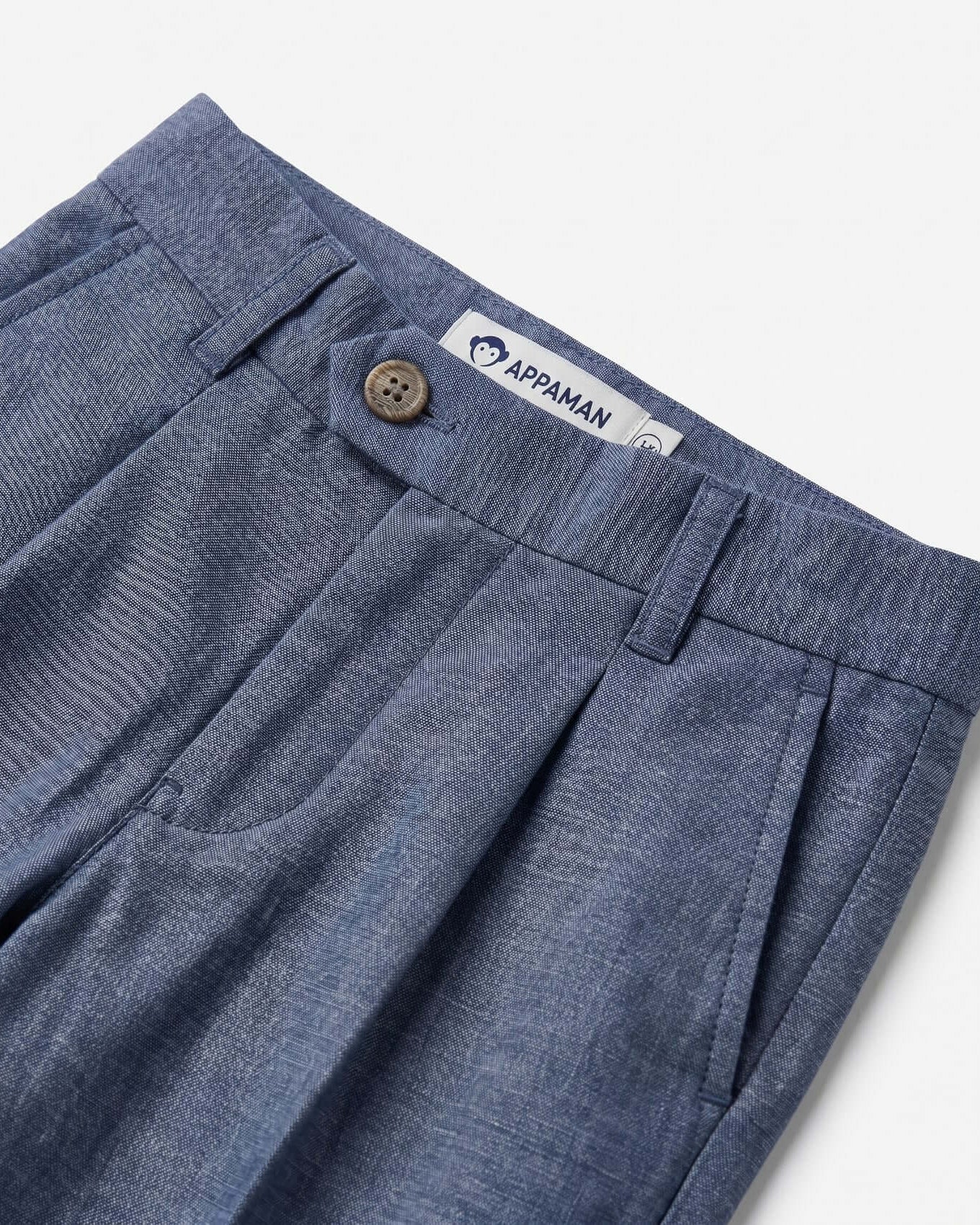 Blue pants with a button and Appaman label on a white background
