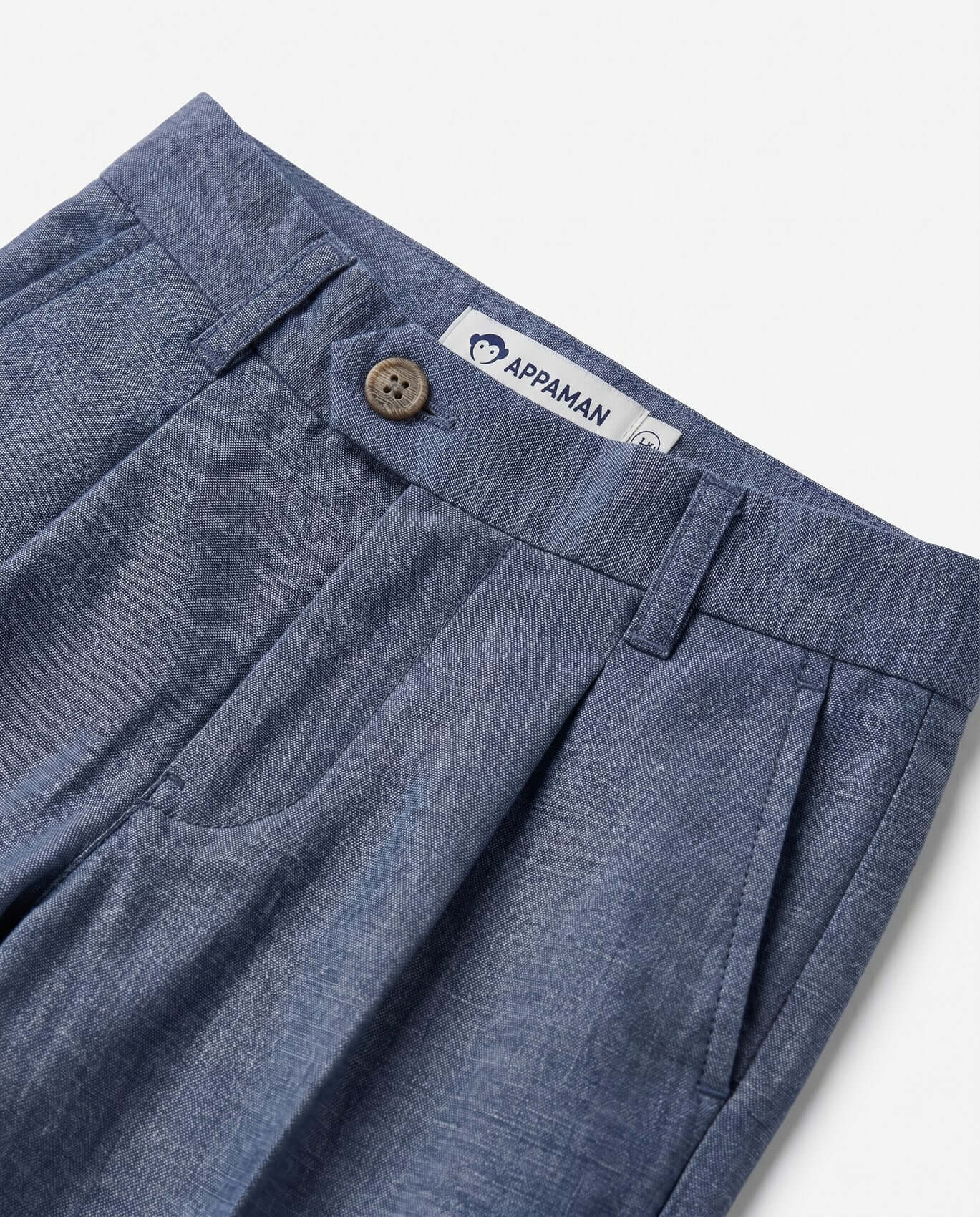 Blue pants with a button and Appaman label on a white background