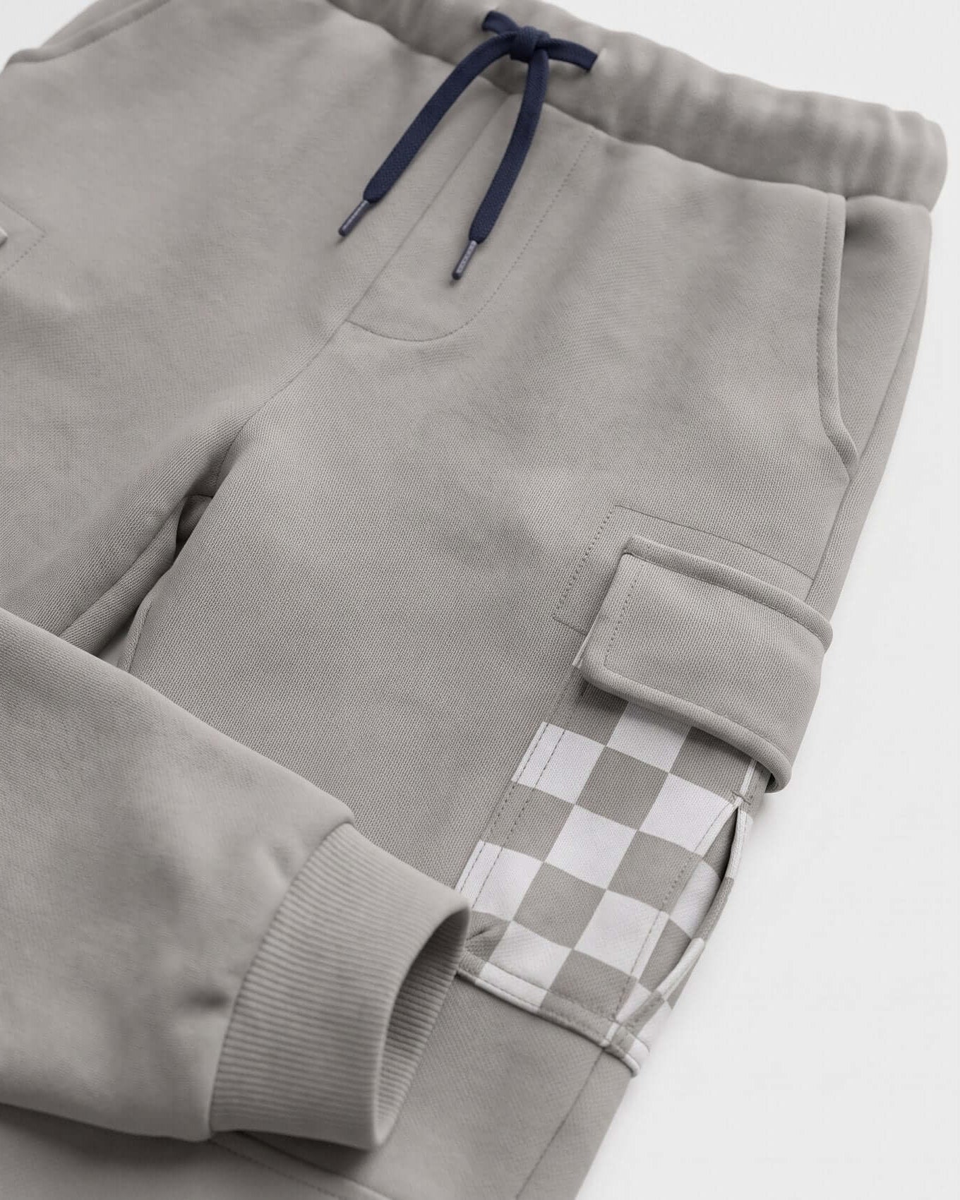 Gray sweatpants with a checkered patch on a white background