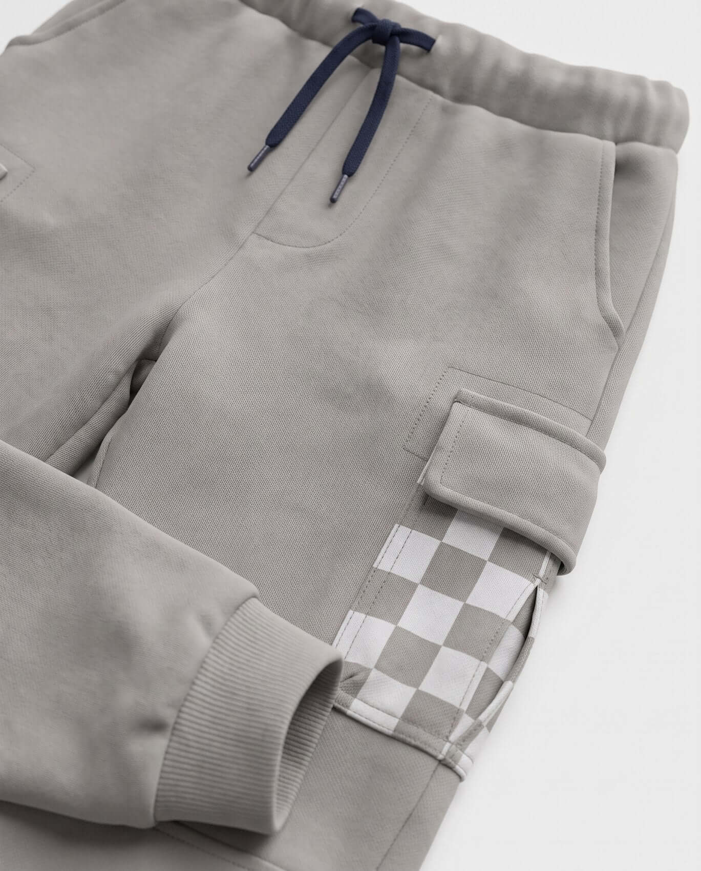 Gray sweatpants with a checkered patch on a white background