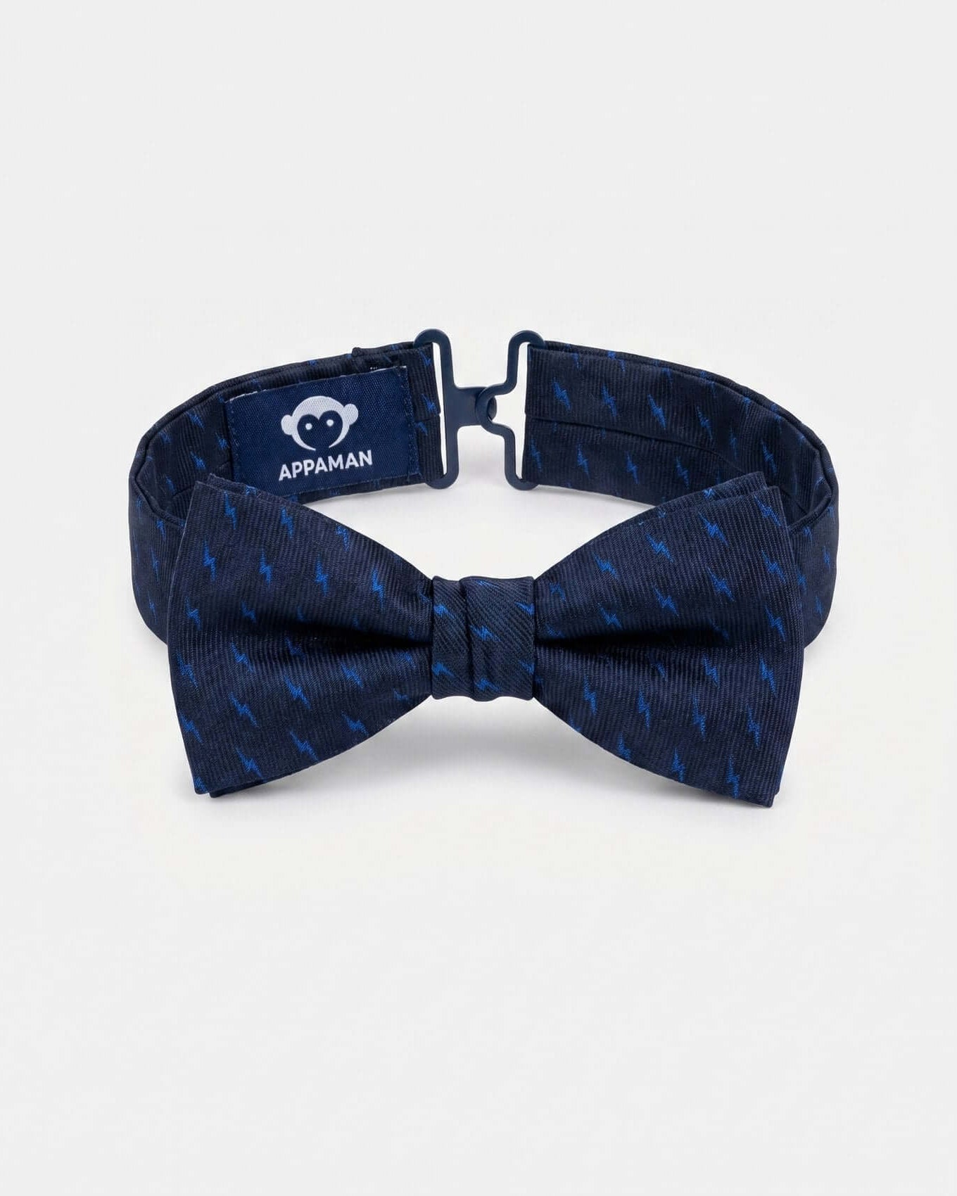 Navy blue bow tie with a pattern on a light gray background