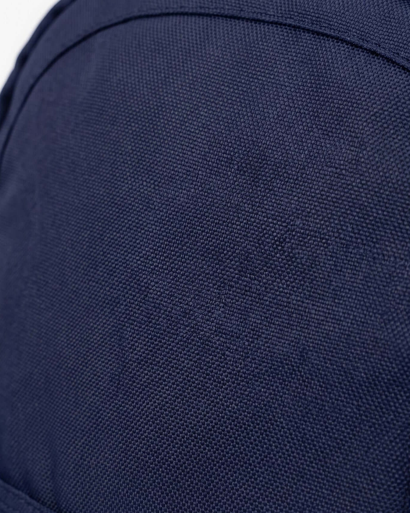 Close-up of a black garment with a brand label on a dark background