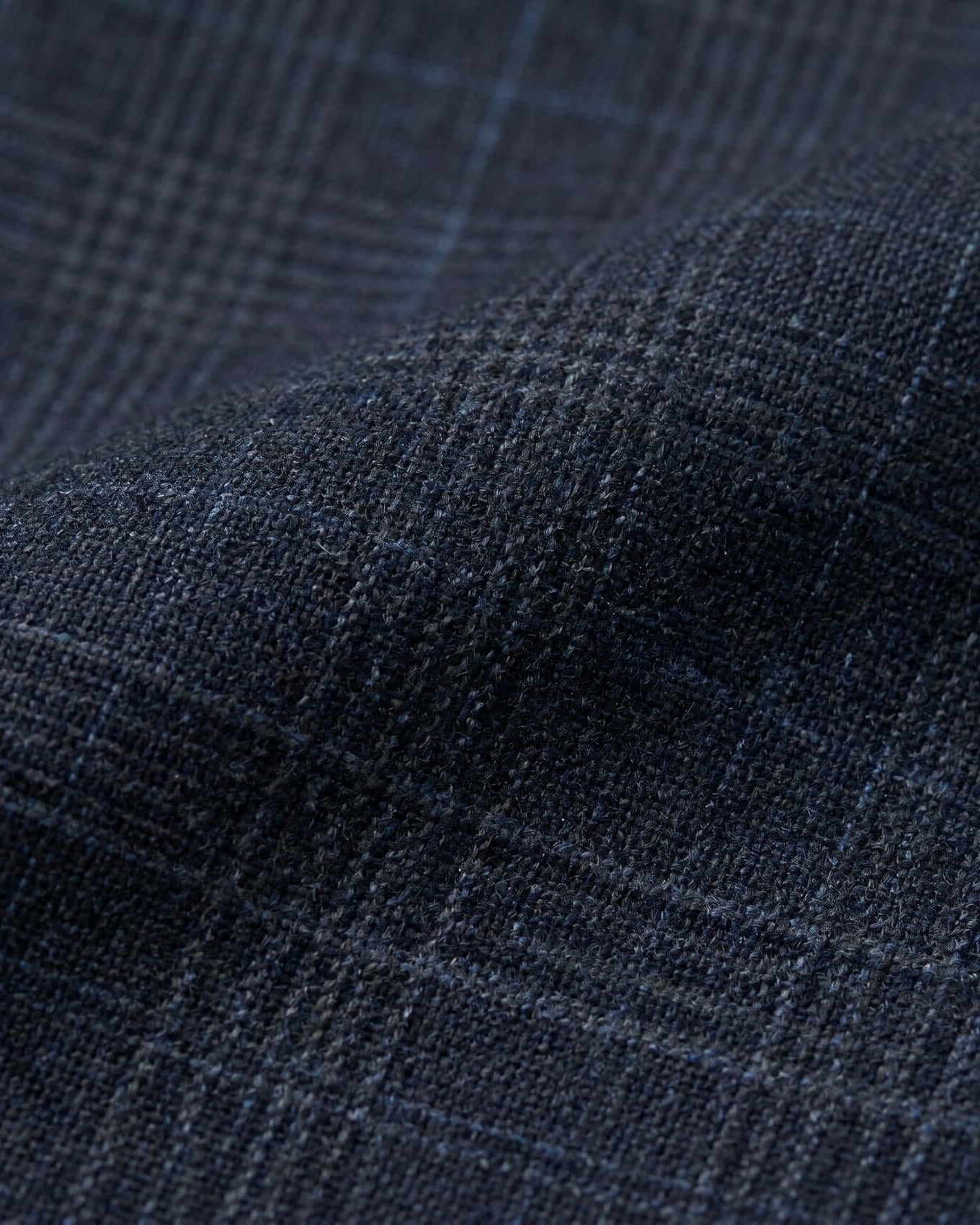 Close-up of dark blue fabric with a subtle pattern