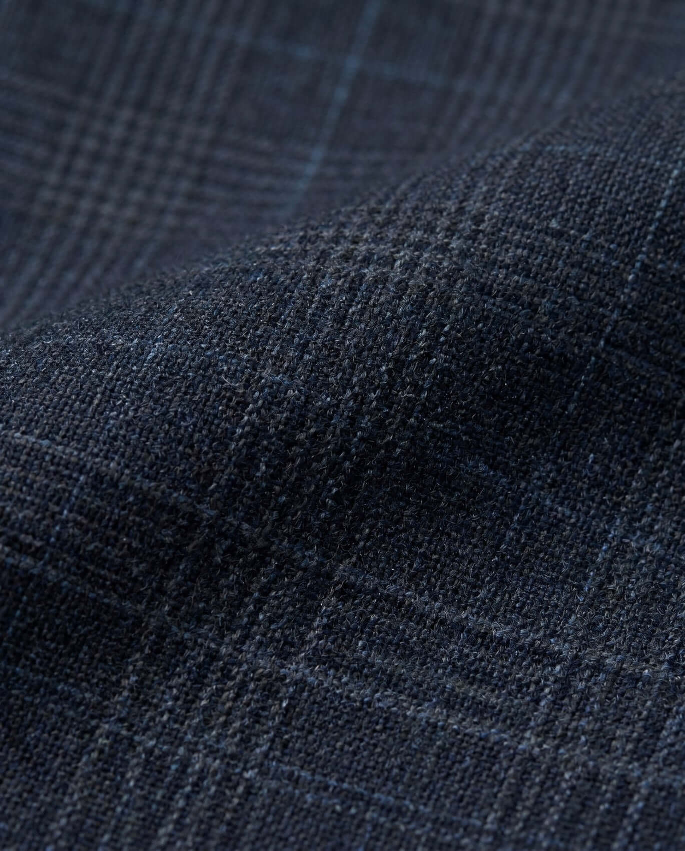 Close-up of dark blue fabric with a subtle pattern