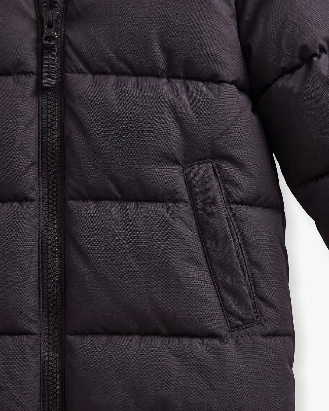 Close-up of a black puffer jacket showing horizontal quilting, a front zipper, and a side pocket against a white background.