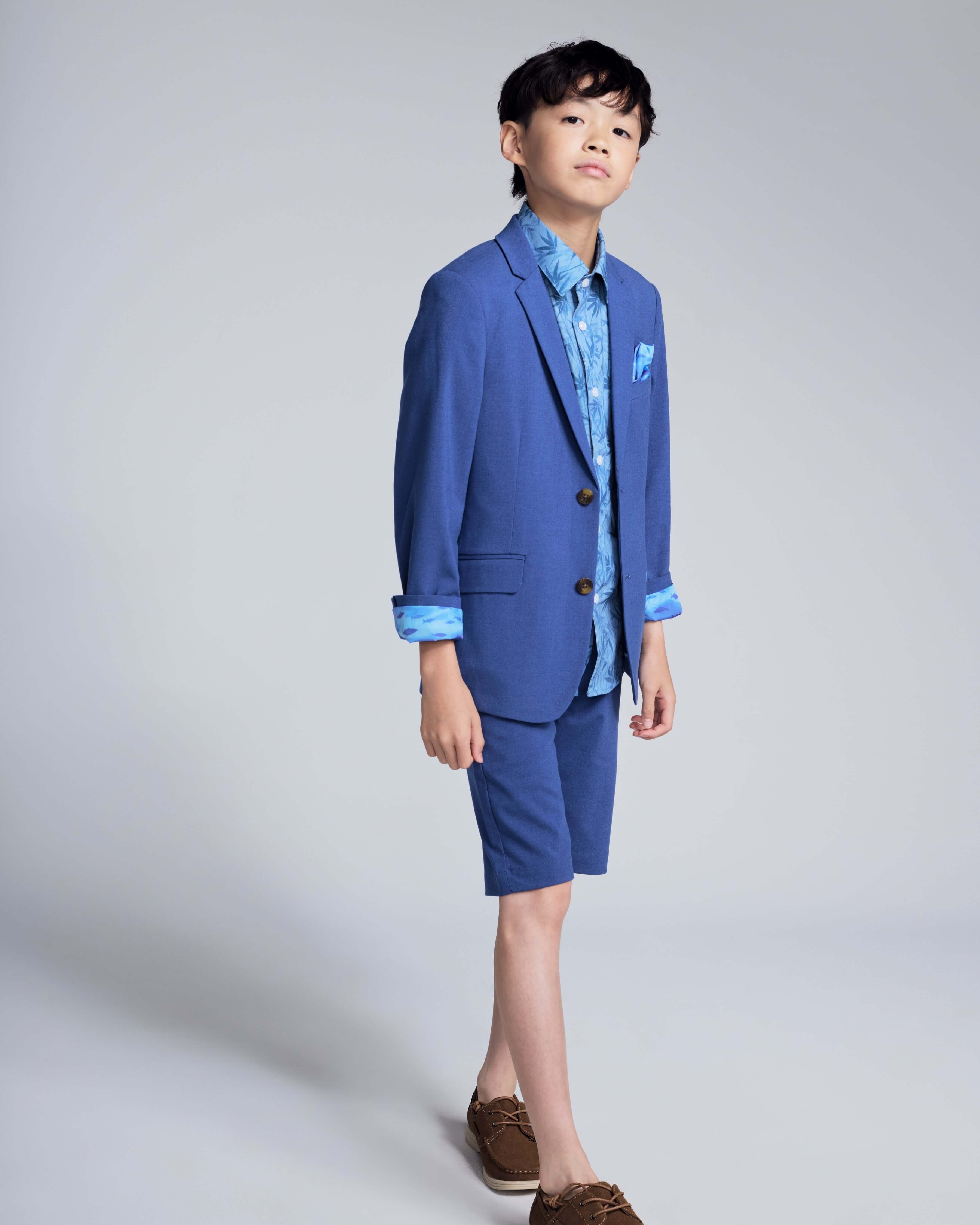 Boy wearing the Canopy Blue Trouser Short with matching jacket, showcasing a polished yet comfortable summer outfit.