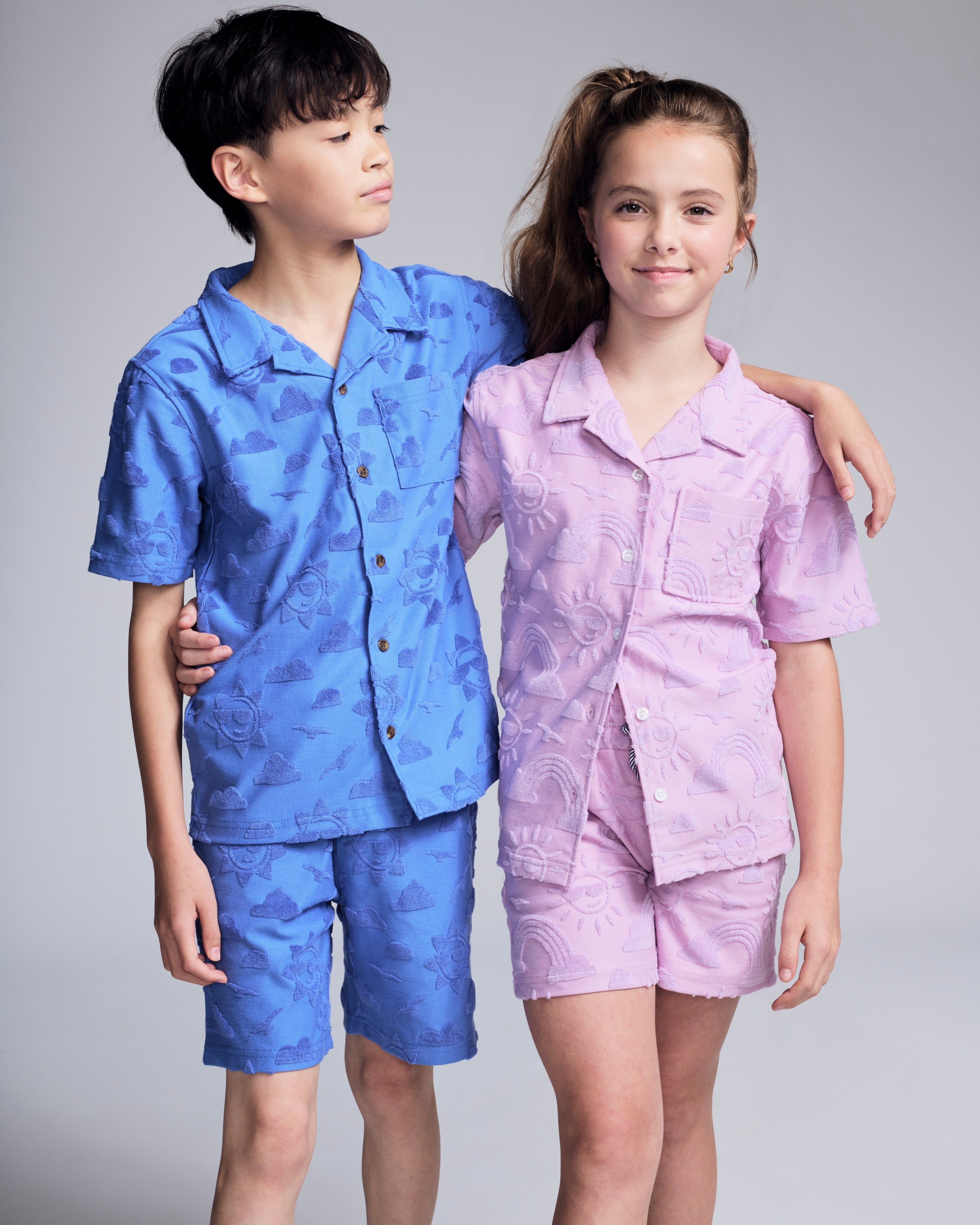 Cobalt Blue Terry Resort Short worn by a boy, paired with a pink resort shirt in a playful setting.