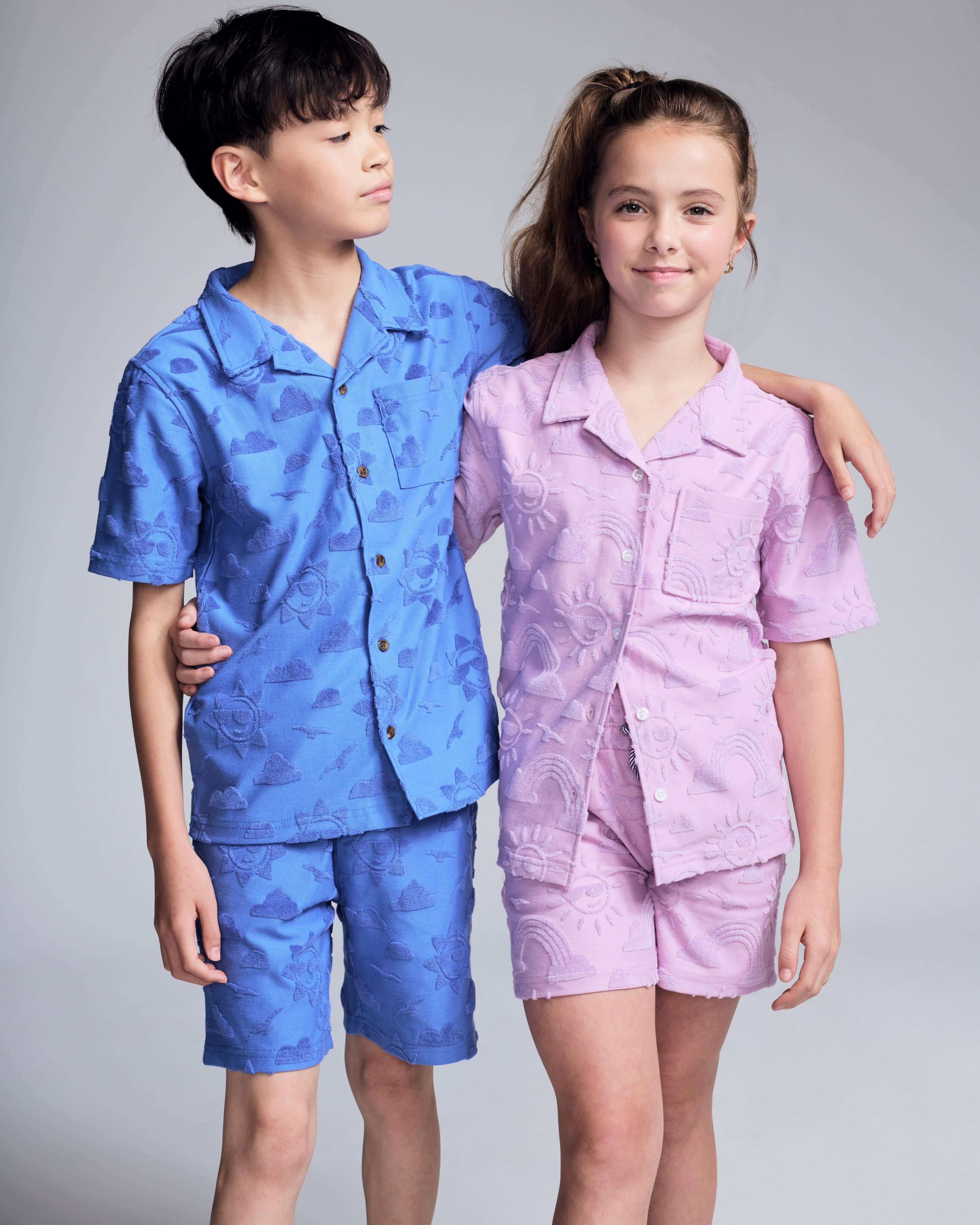 Cobalt Blue Terry Resort Short worn by a boy, paired with a pink resort shirt in a playful setting.