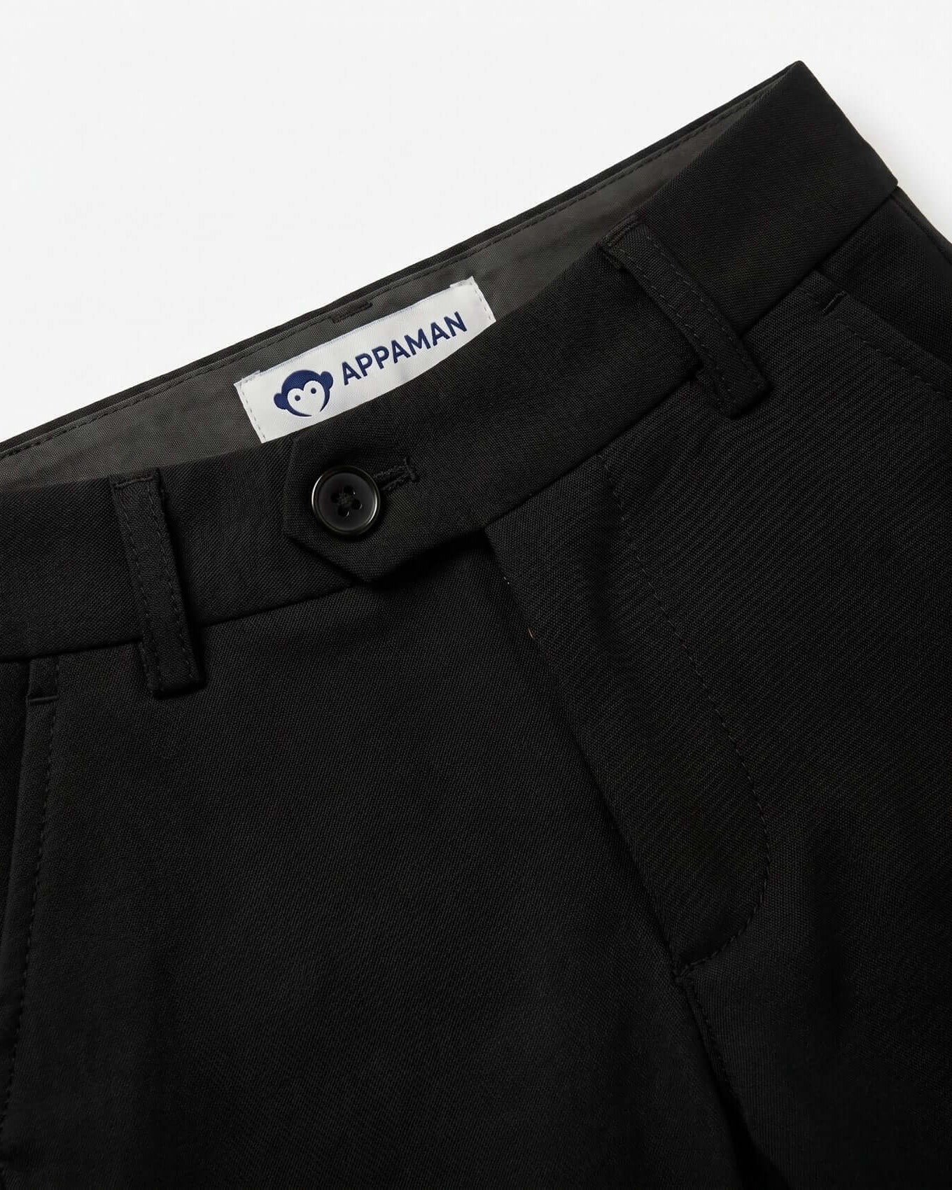 Close-up of black pants with a visible Appaman label on a white background