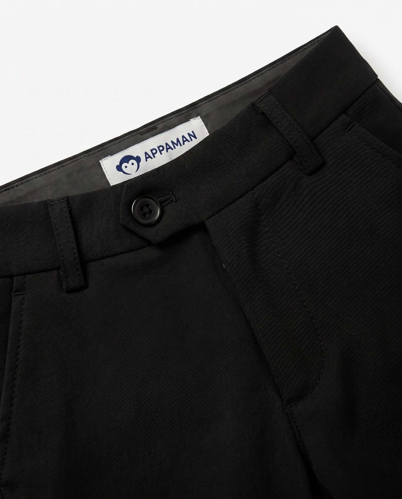 Close-up of black pants with a visible Appaman label on a white background