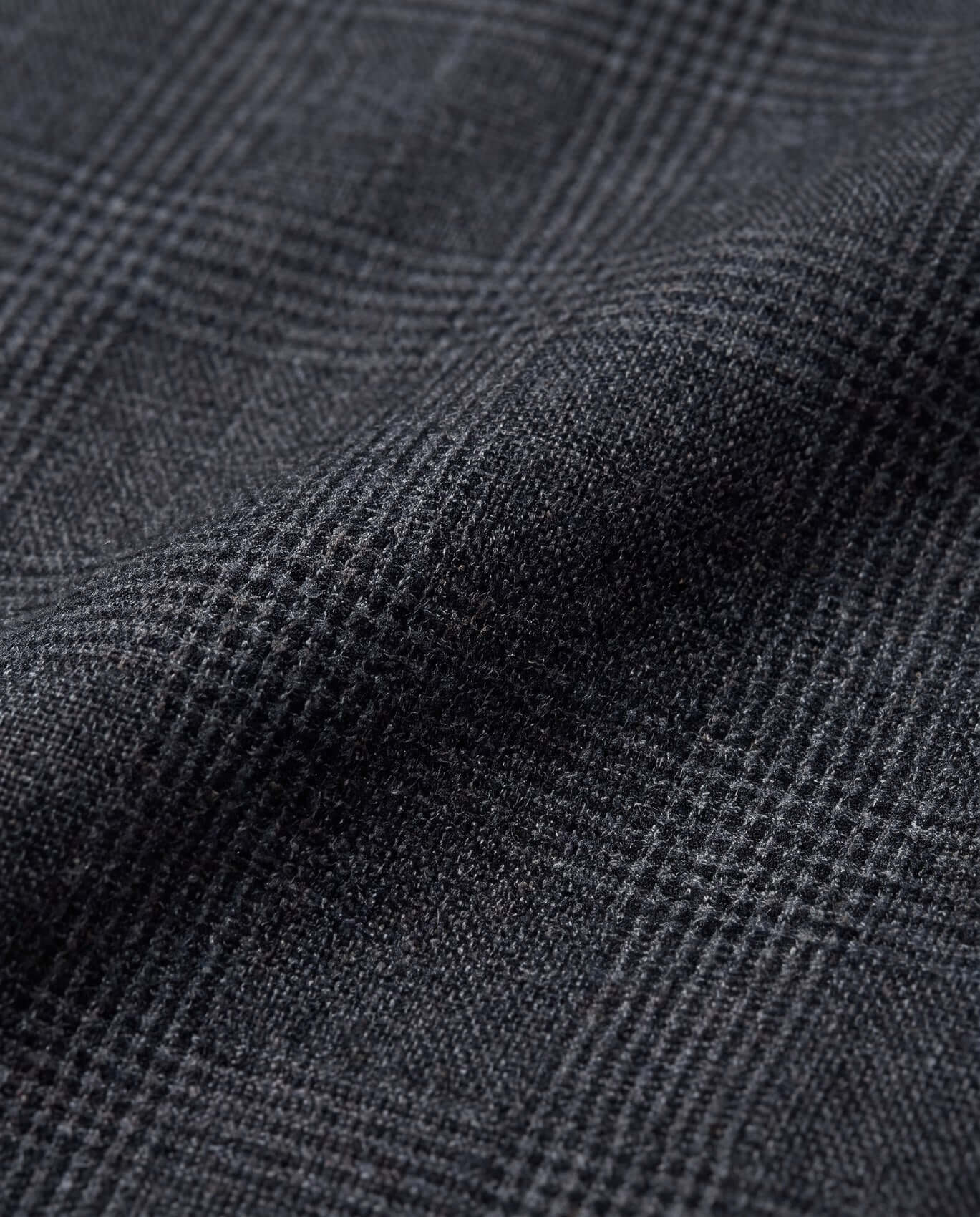 Close-up of dark gray fabric with a subtle check pattern