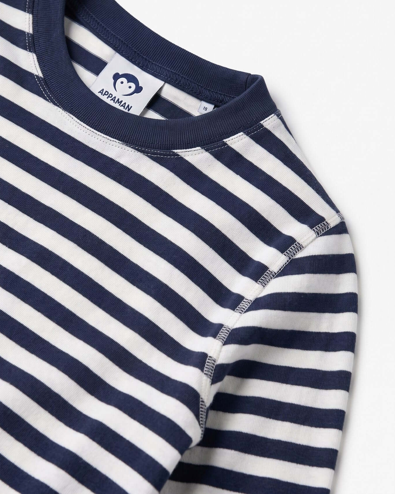 Navy and white striped shirt with Appaman label on a light gray background