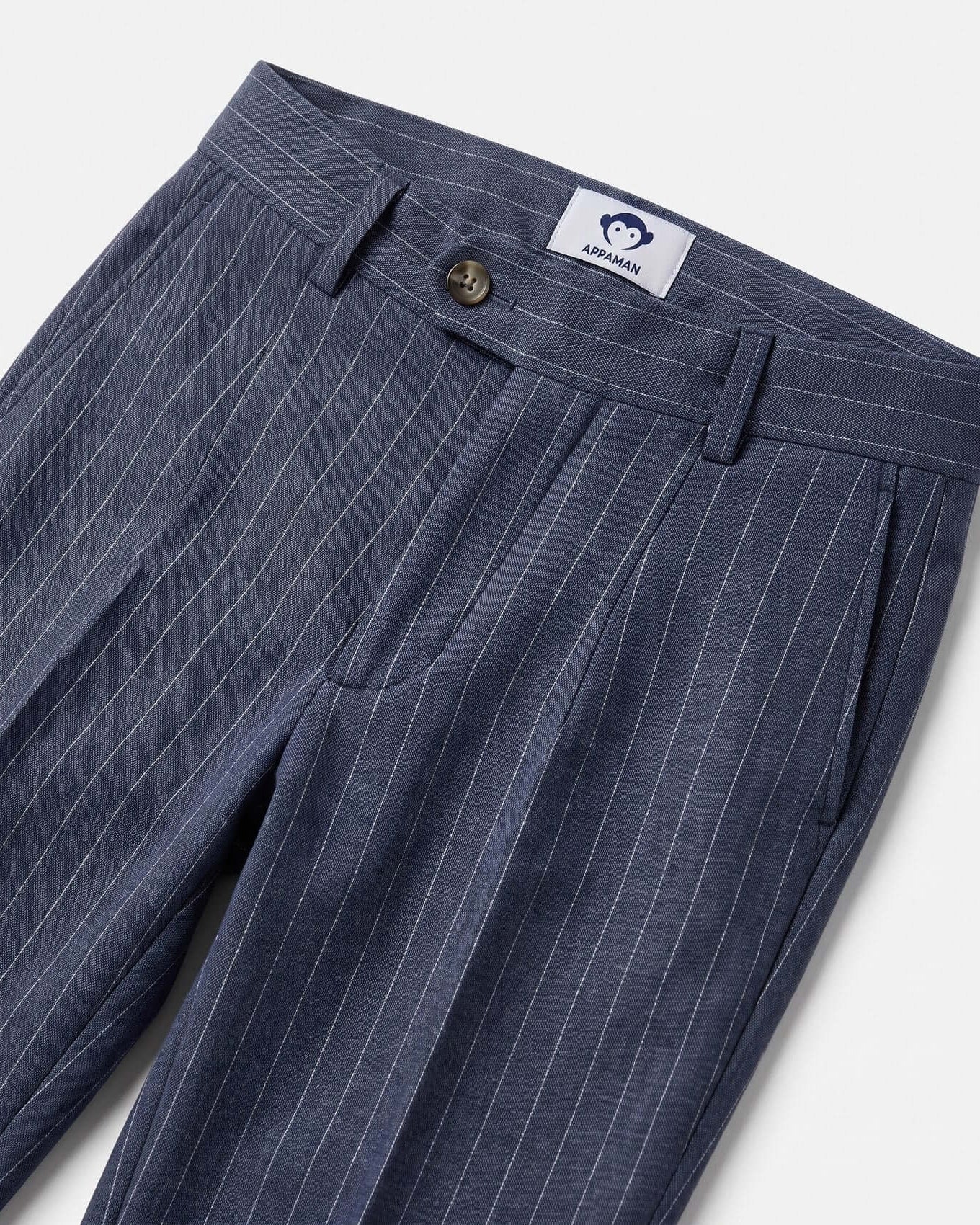 Blue pinstripe pants with a brand label on a light gray background