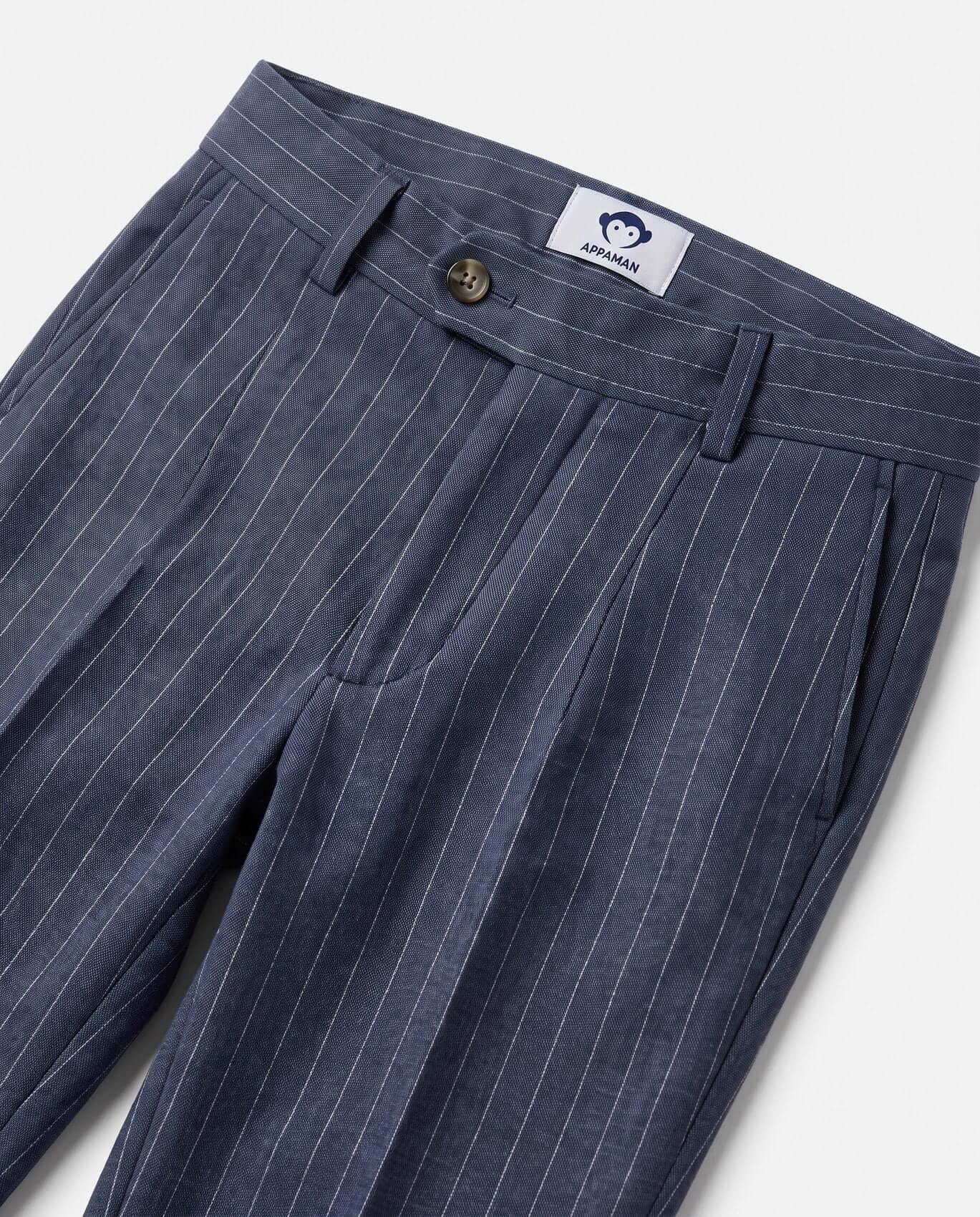 Blue pinstripe pants with a brand label on a light gray background
