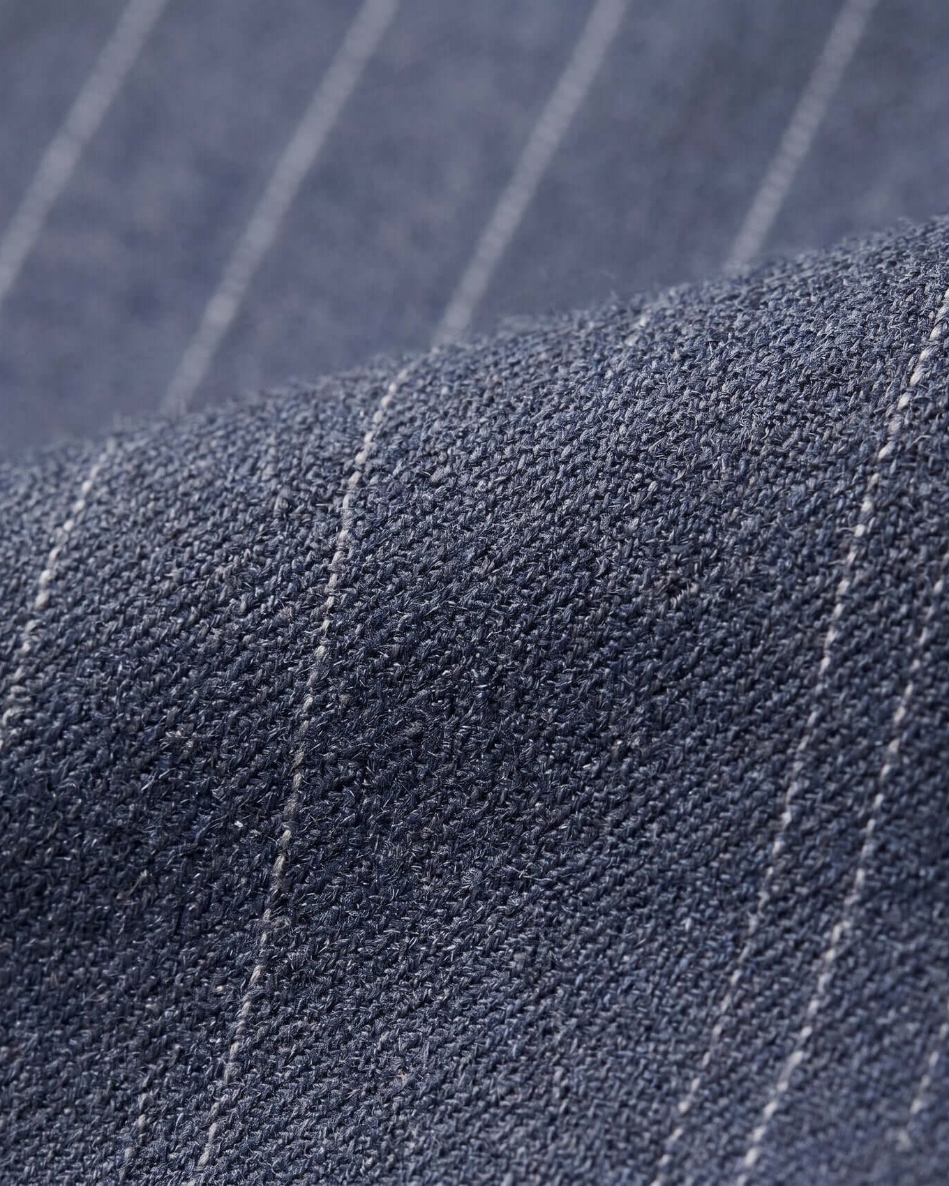 Close-up of blue fabric with white pinstripes
