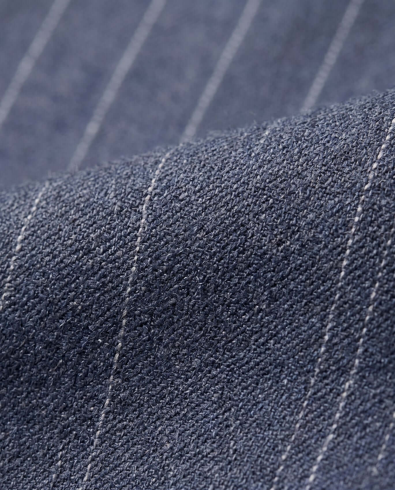 Close-up of blue fabric with white pinstripes