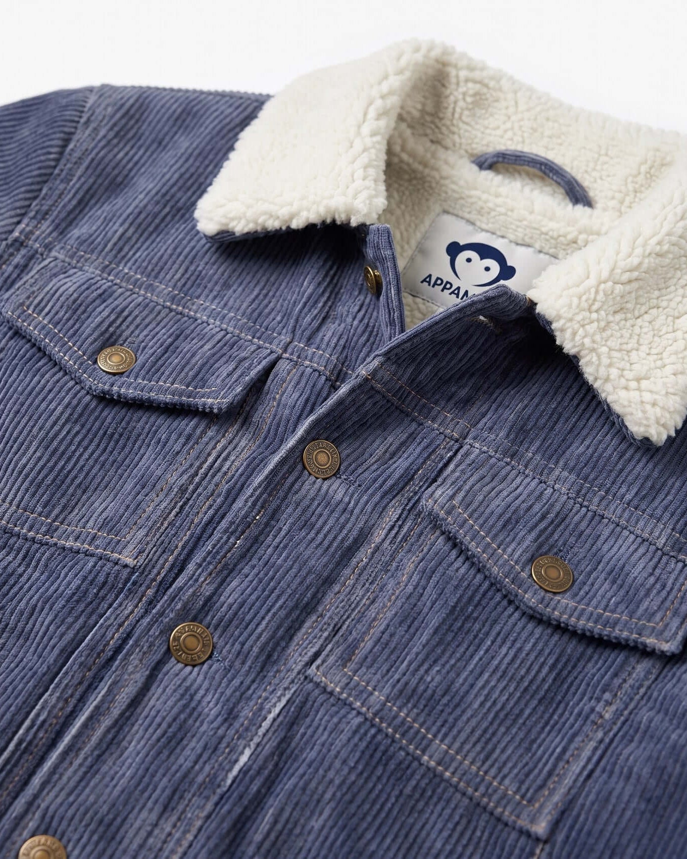 Blue denim jacket with white sherpa lining and a visible brand label.