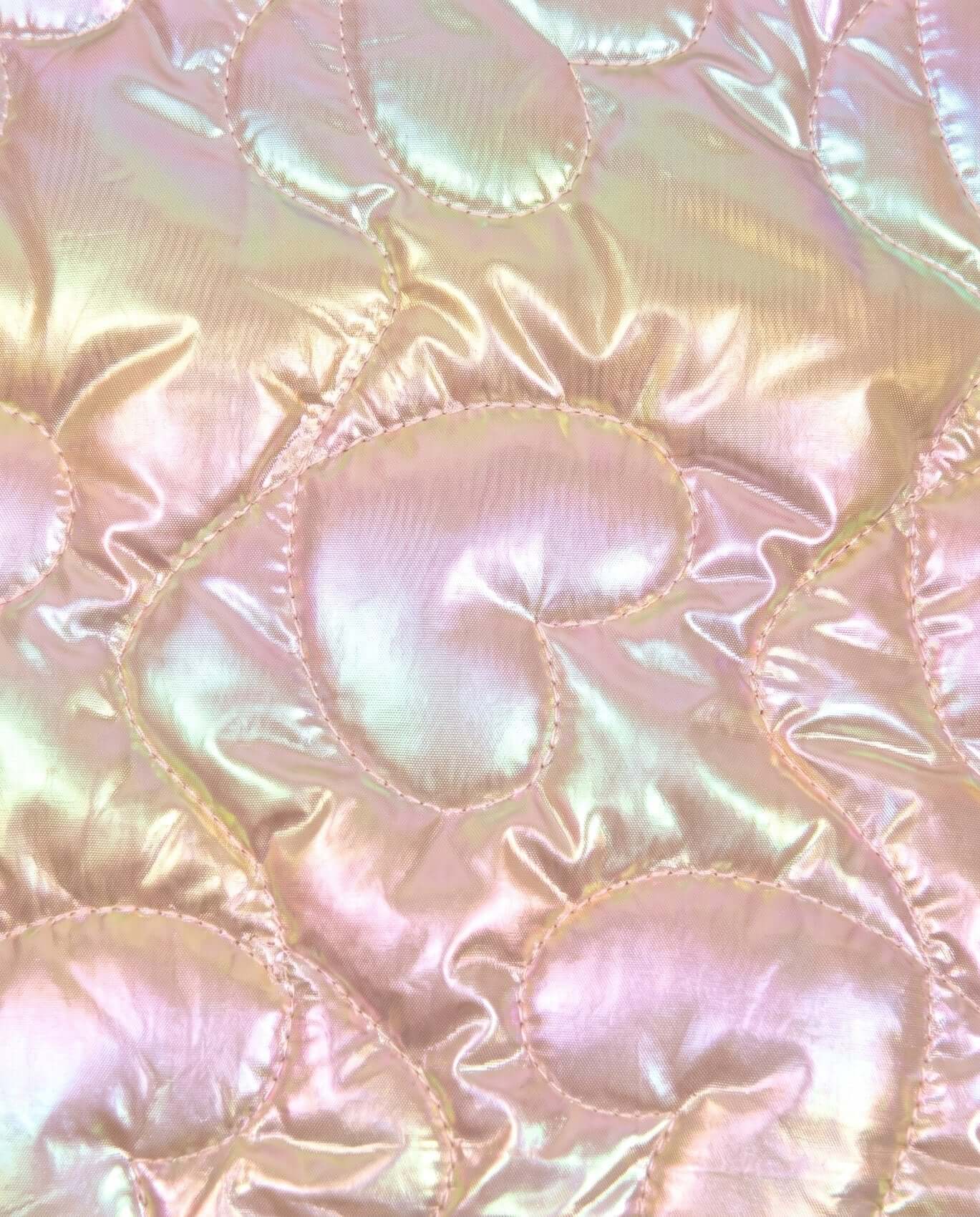 Close-up of iridescent quilted fabric with circular patterns