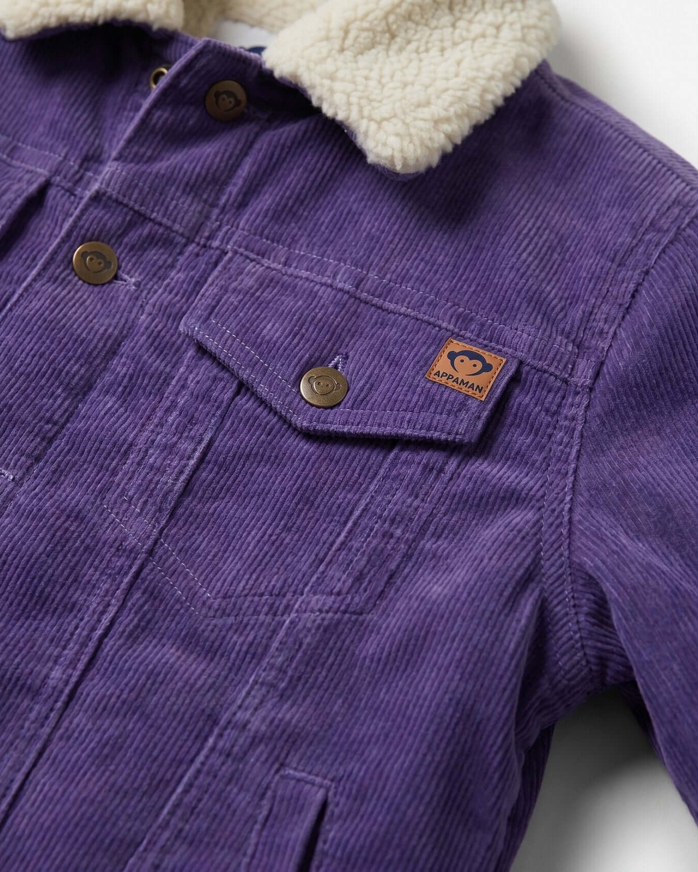 Purple corduroy jacket with a cream sherpa lining on a white background