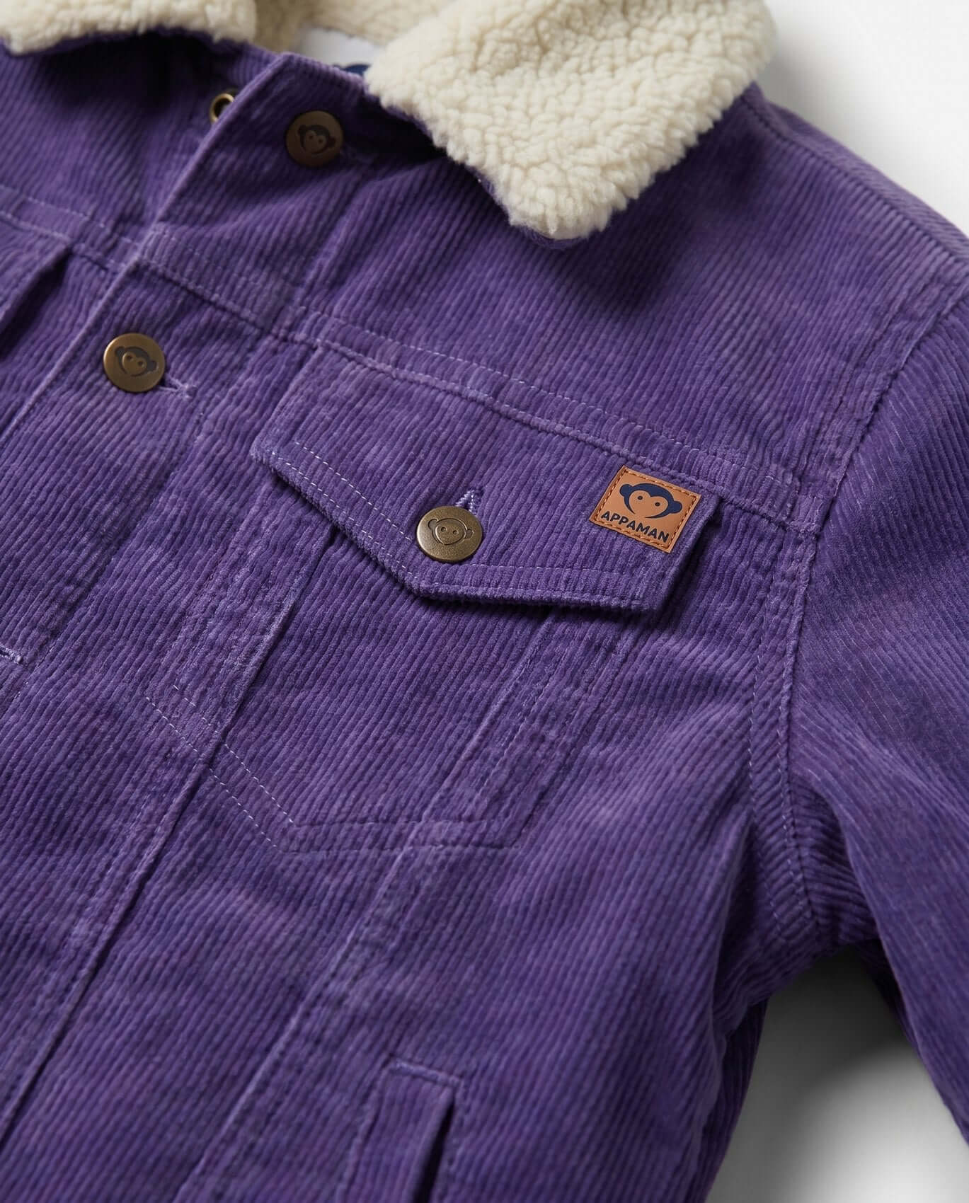 Purple corduroy jacket with a cream sherpa lining on a white background
