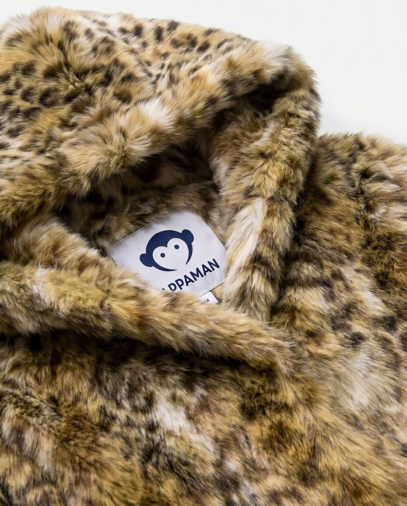 Close-up of a leopard print fabric with a brand label inside.