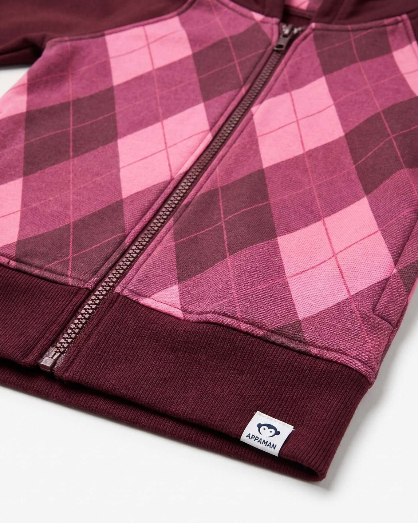 Pink and purple plaid jacket with a visible brand logo on a white background