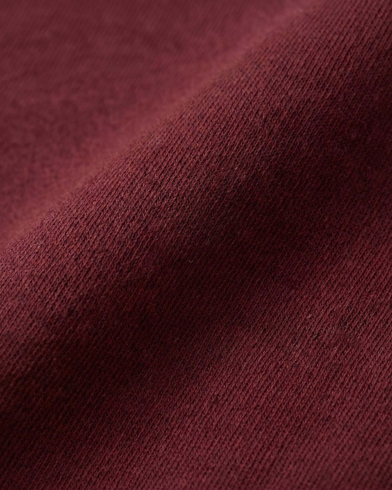 Close-up of a textured burgundy fabric surface