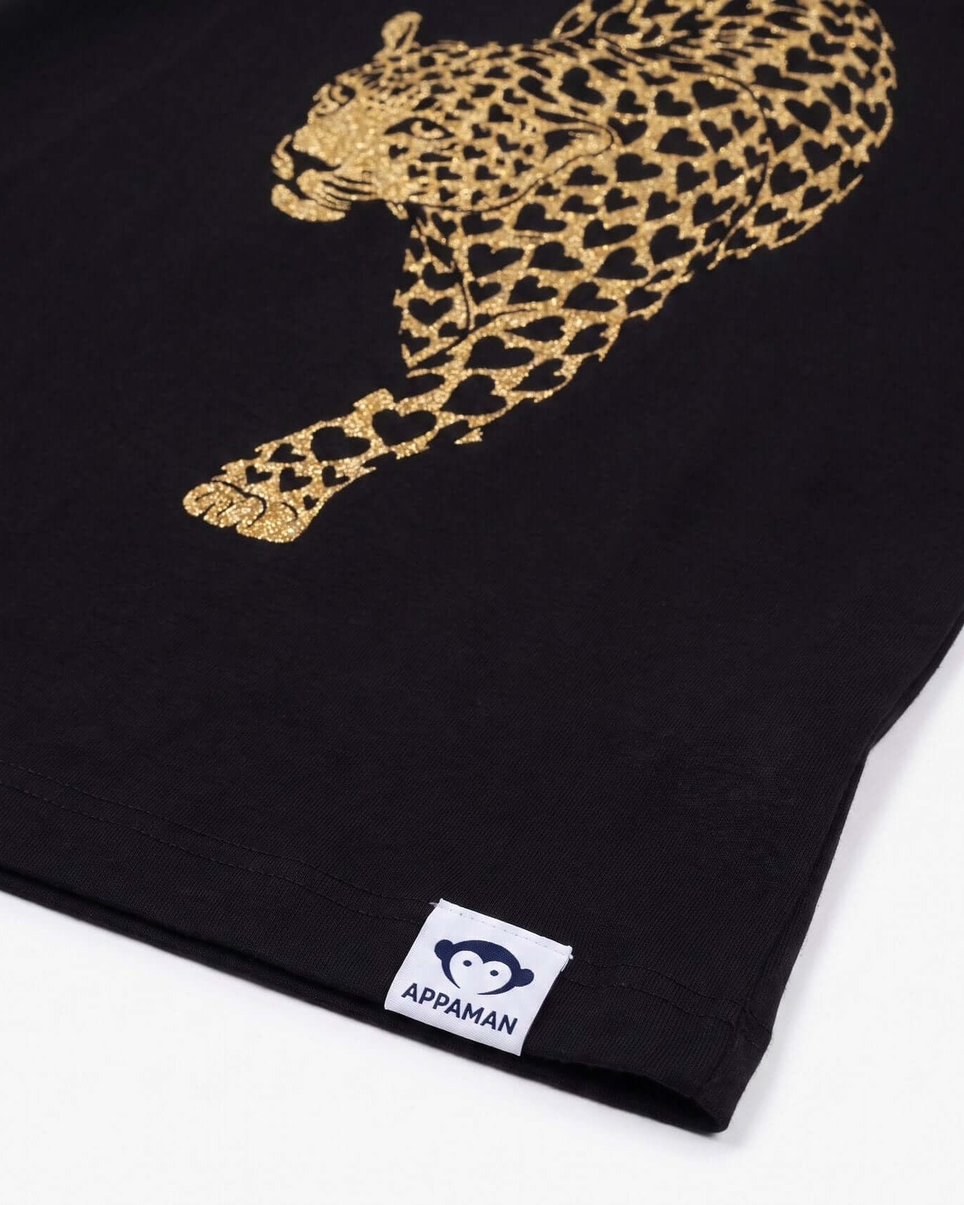 Black shirt with gold leopard design and Appaman label on a white background