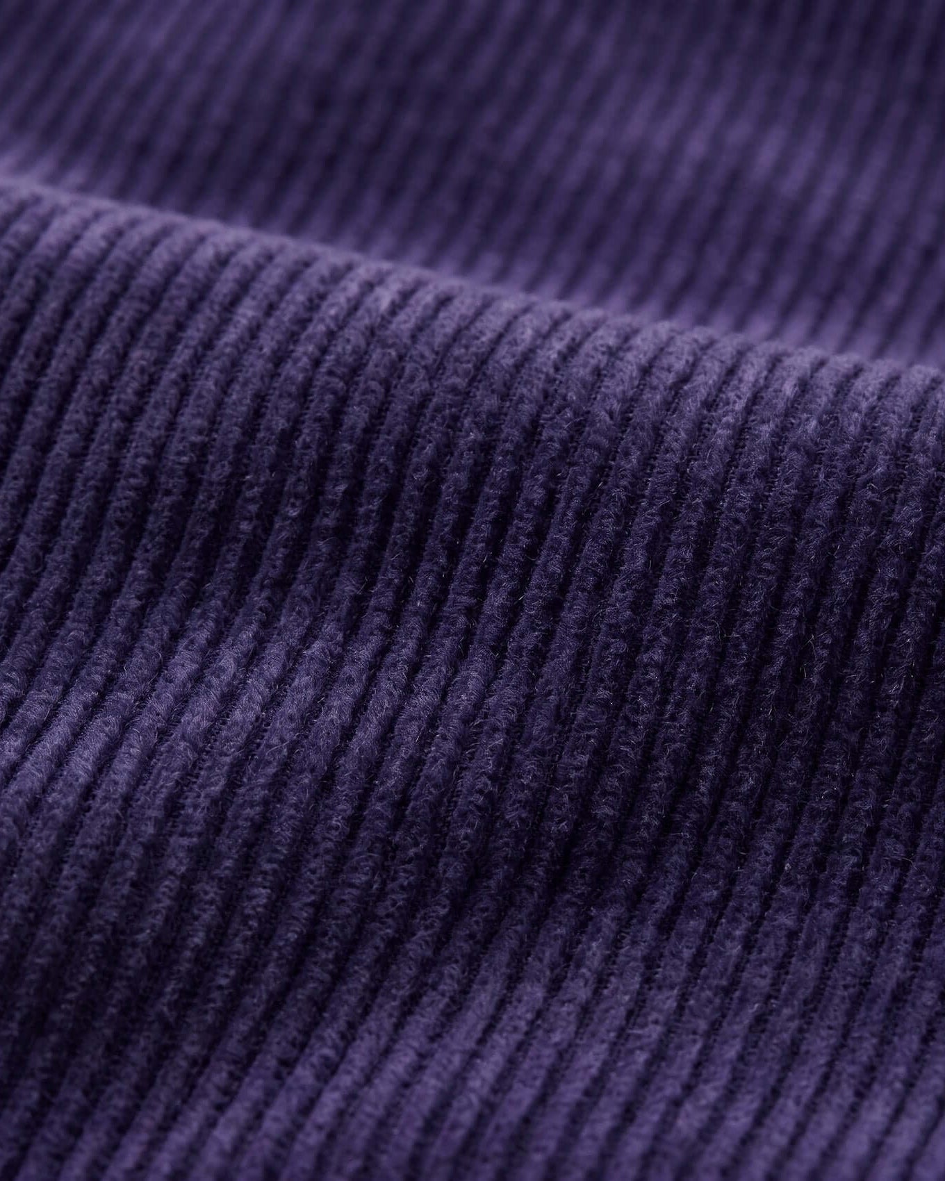 Close-up of purple corduroy fabric texture