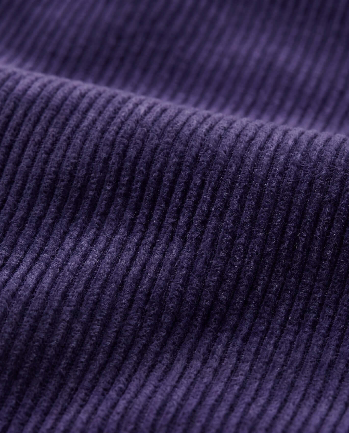 Close-up of purple corduroy fabric texture