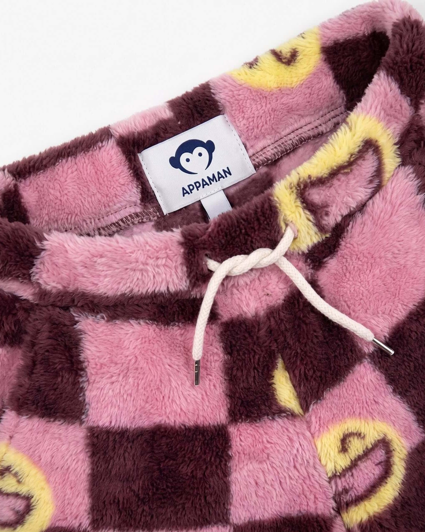 Pink and brown checkered blanket with yellow accents and Appaman label.