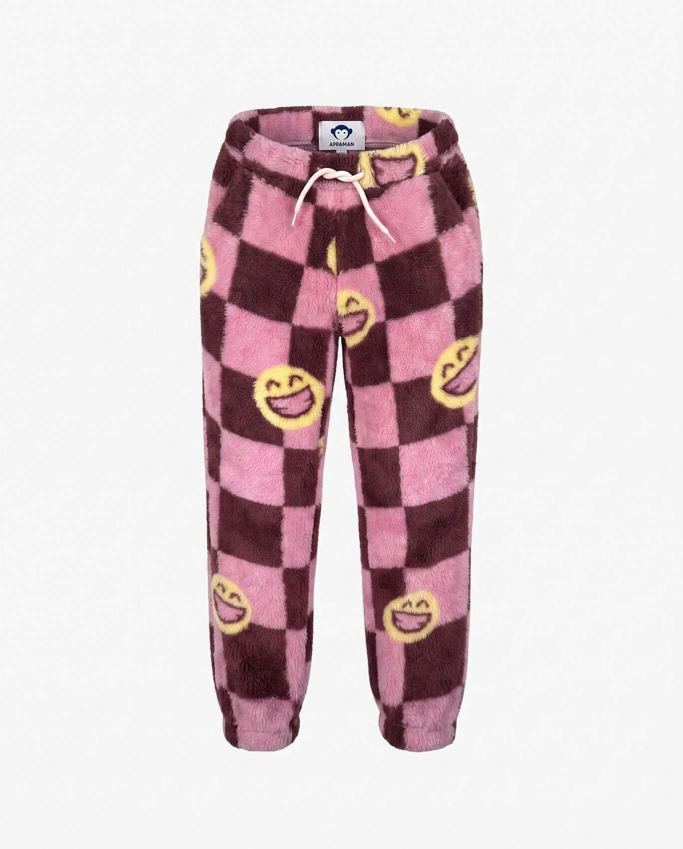 Pink and purple checkered pants with smiley face designs on a white background