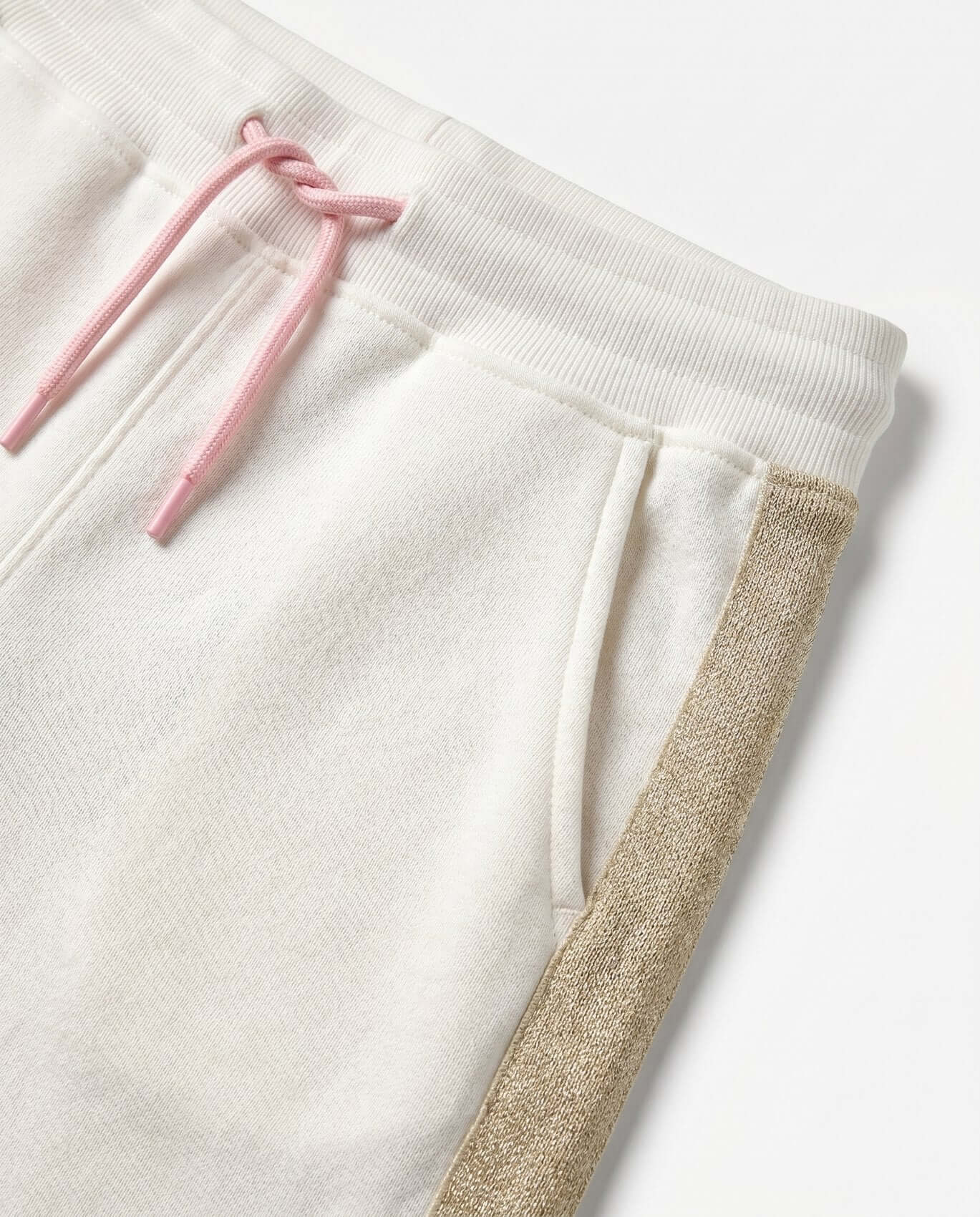White sweatpants with pink drawstring and gold trim on a white background