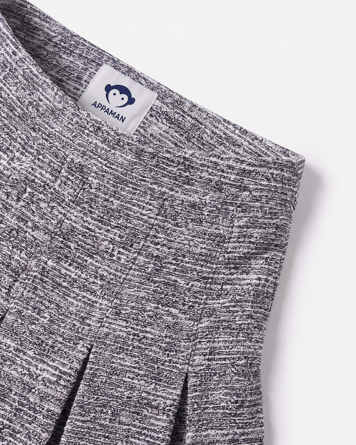 Close-up of a gray marled fabric with Appaman label on a white background