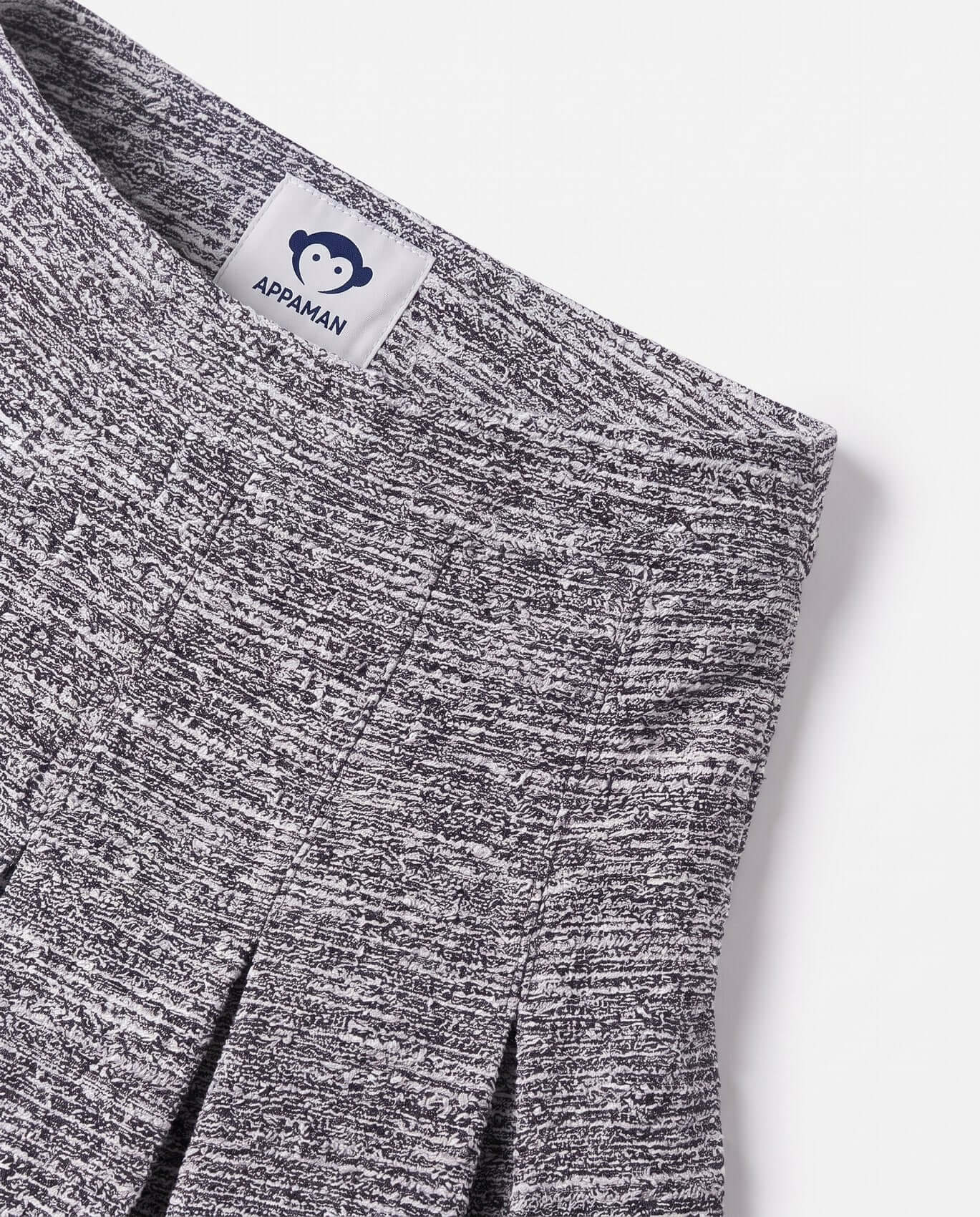 Close-up of a gray marled fabric with Appaman label on a white background