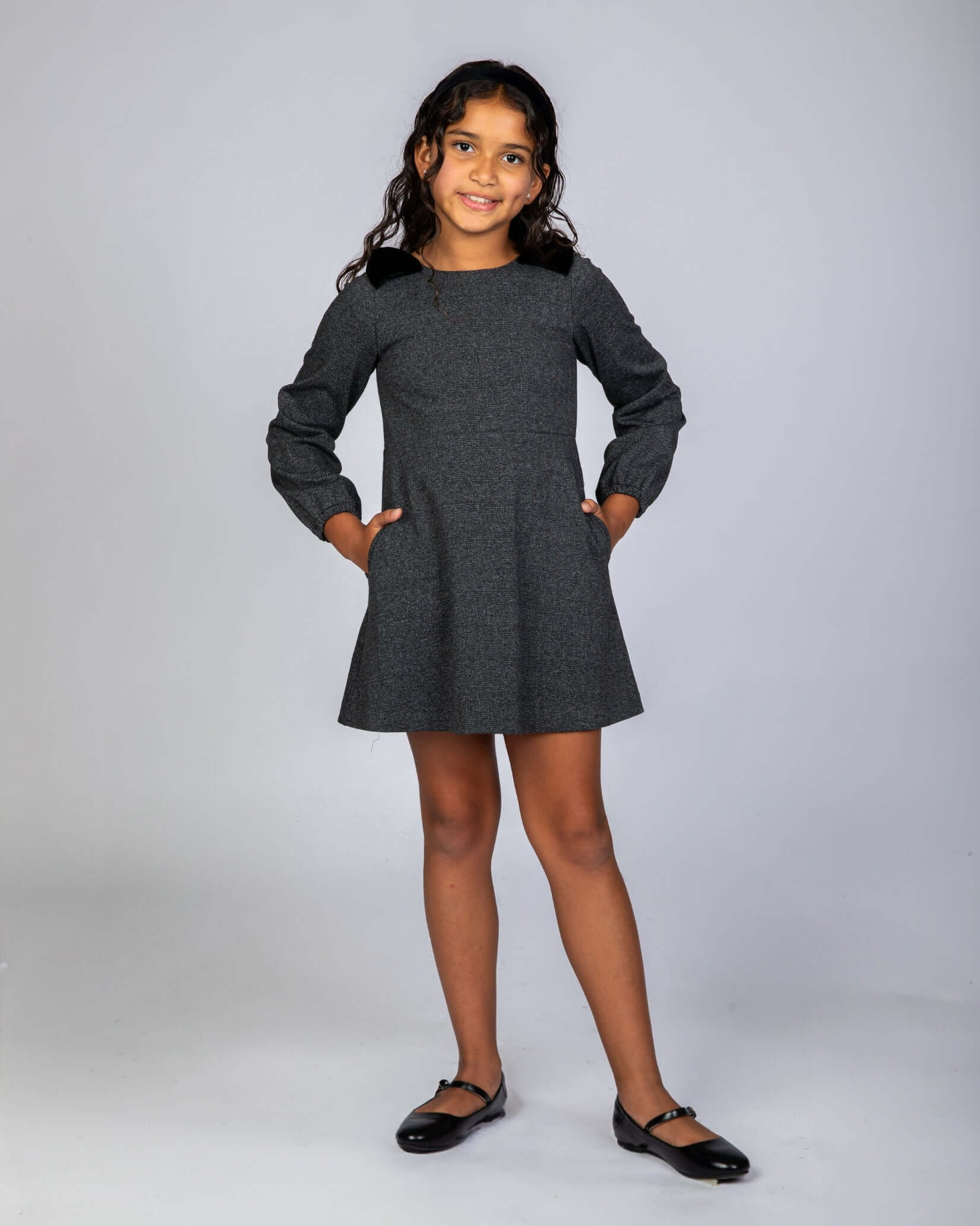 Noir Micro Plaid Blair Bow Dress on a girl, showcasing oversized bows and A-line silhouette.