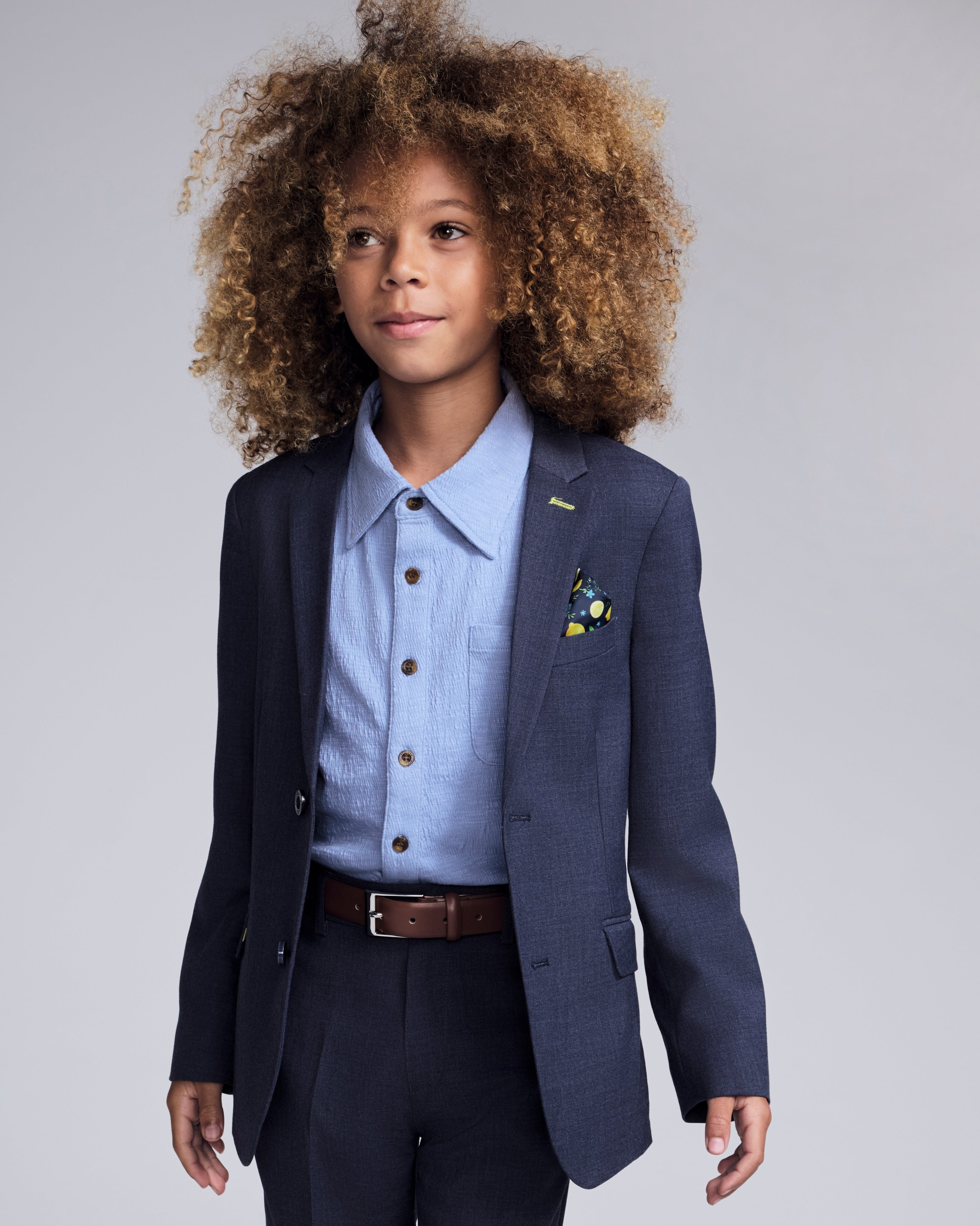 Stylish boy in a Glacier Lake Beach Shirt with a blazer, showcasing a polished look for summer occasions.