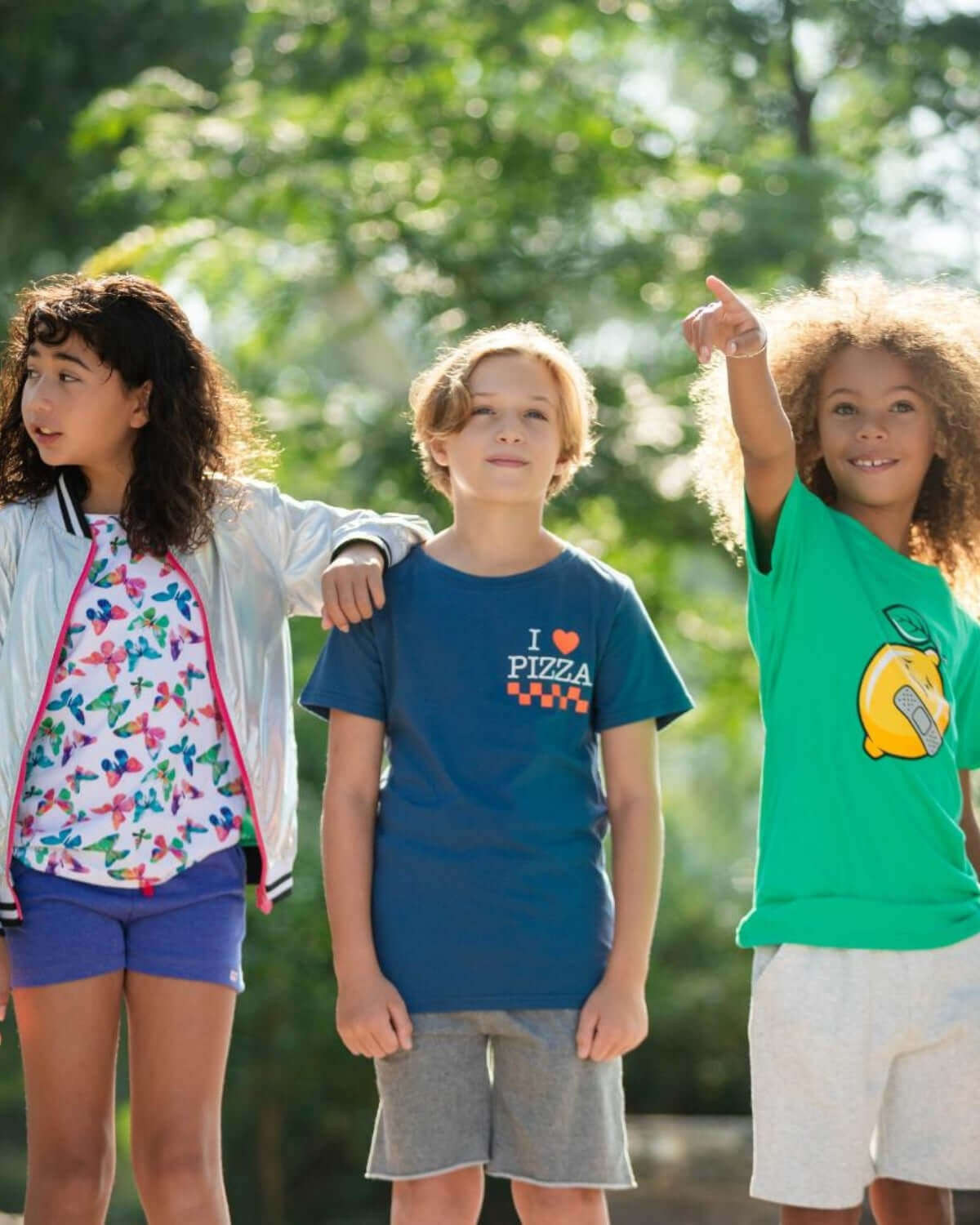 Stylish kids in colorful outfits enjoying playtime outdoors, showcasing fun and trendy kids clothes for back to school.