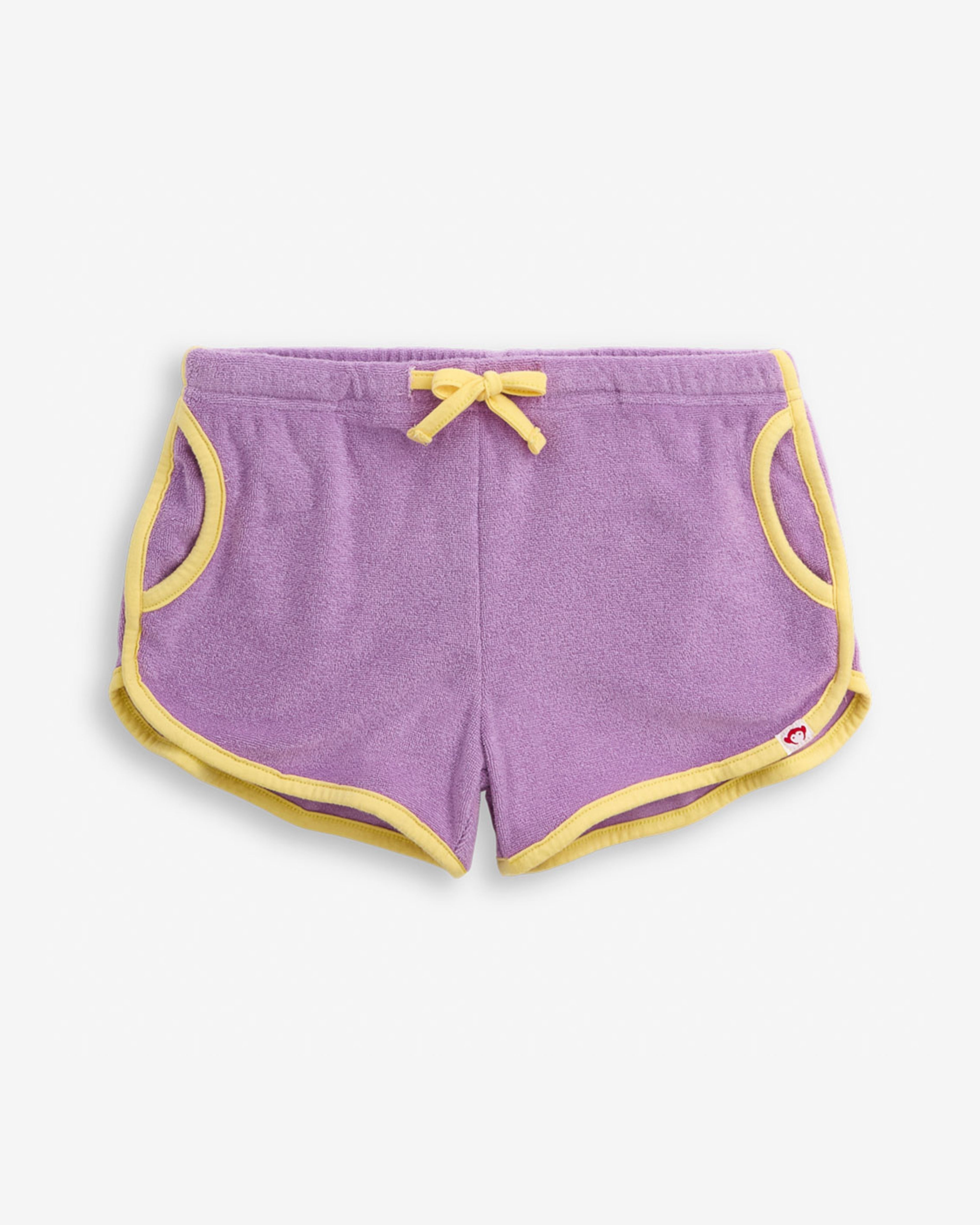 Lilac Terry Sierra Short featuring a soft lilac color with yellow trim and adjustable waistband for girls.