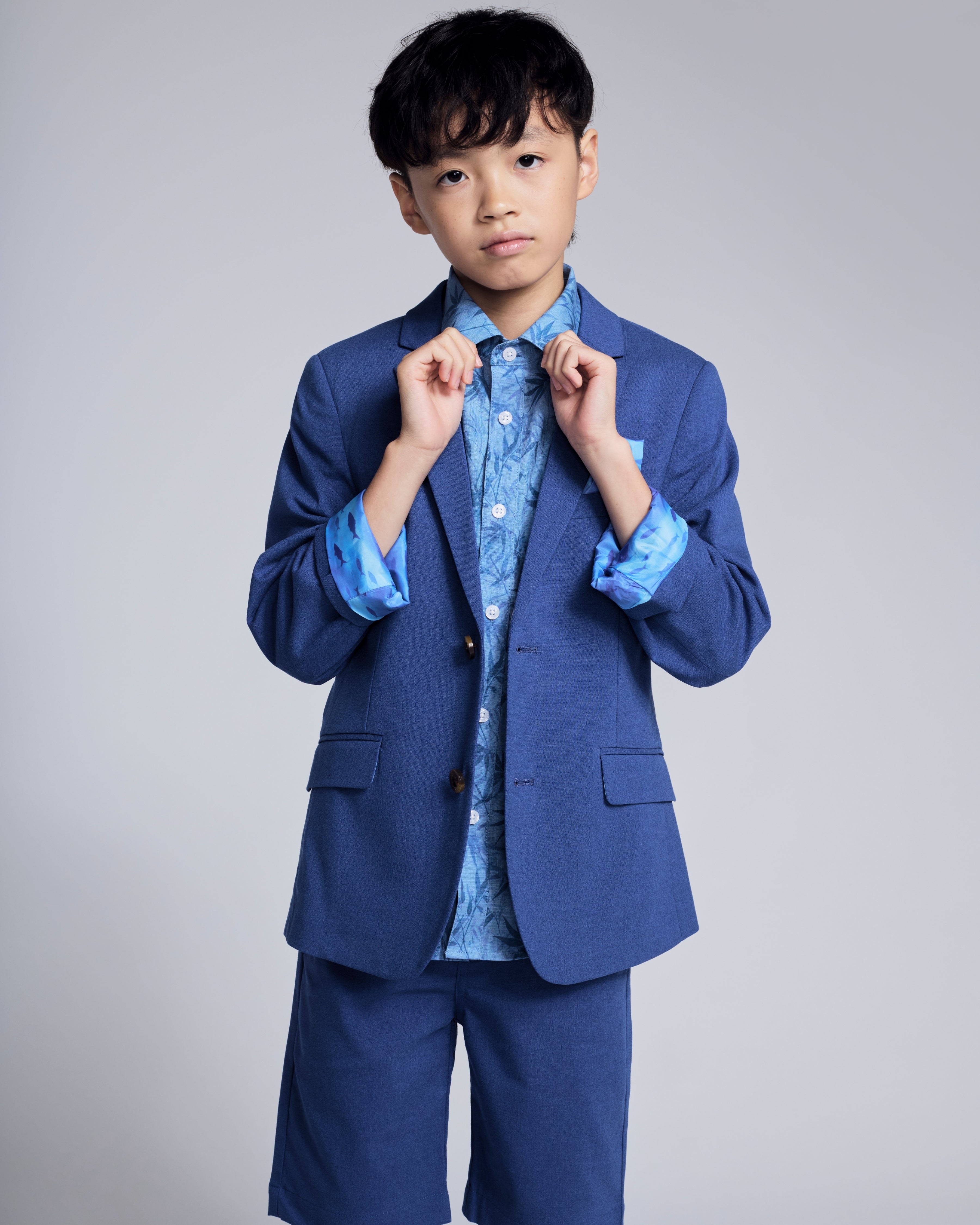 Linen Canopy Blue Sports Jacket paired with a blue patterned shirt and shorts, stylish for spring events.