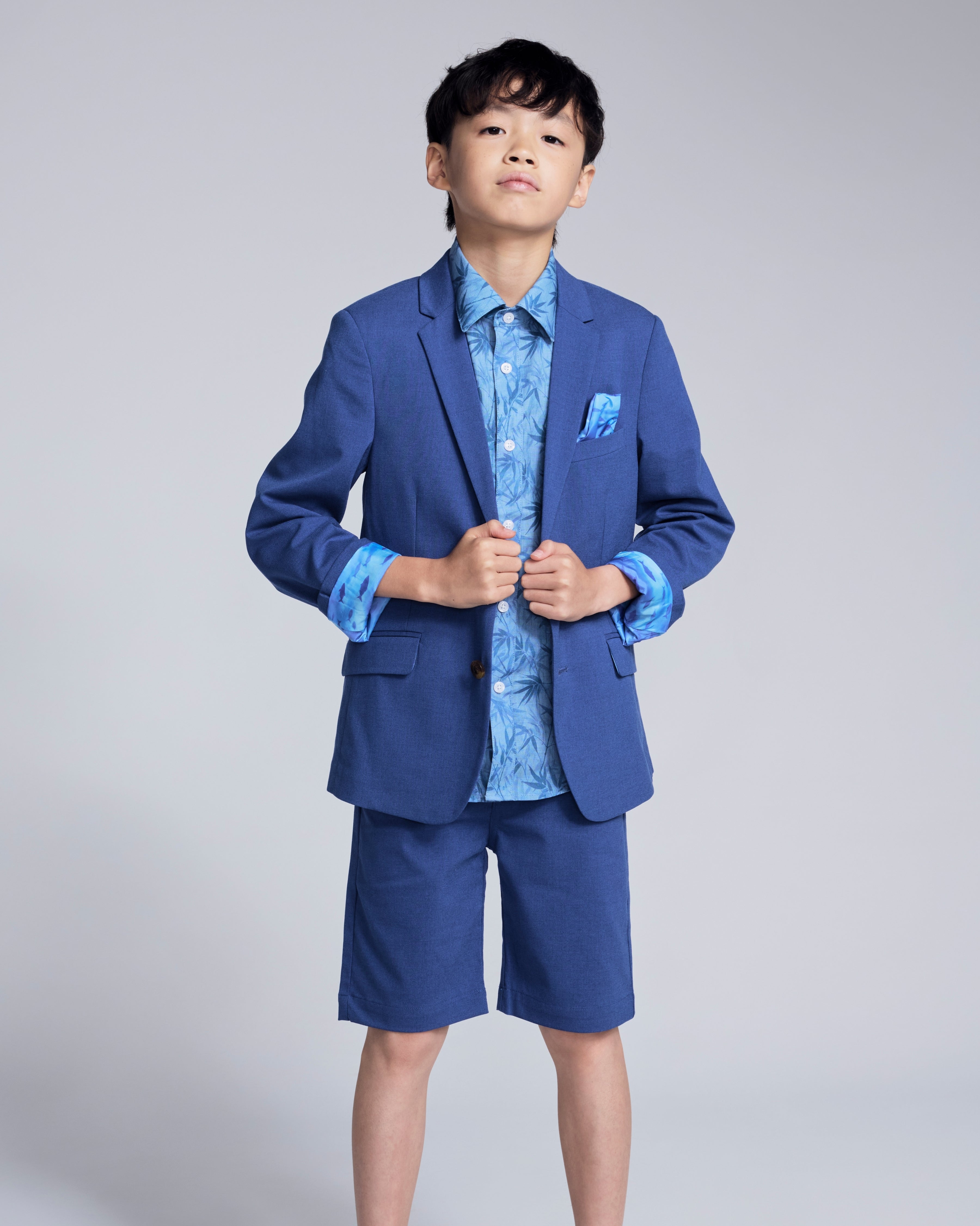 Linen Canopy Blue Sports Jacket worn by a boy, showcasing a stylish spring look with shorts and a pocket square.